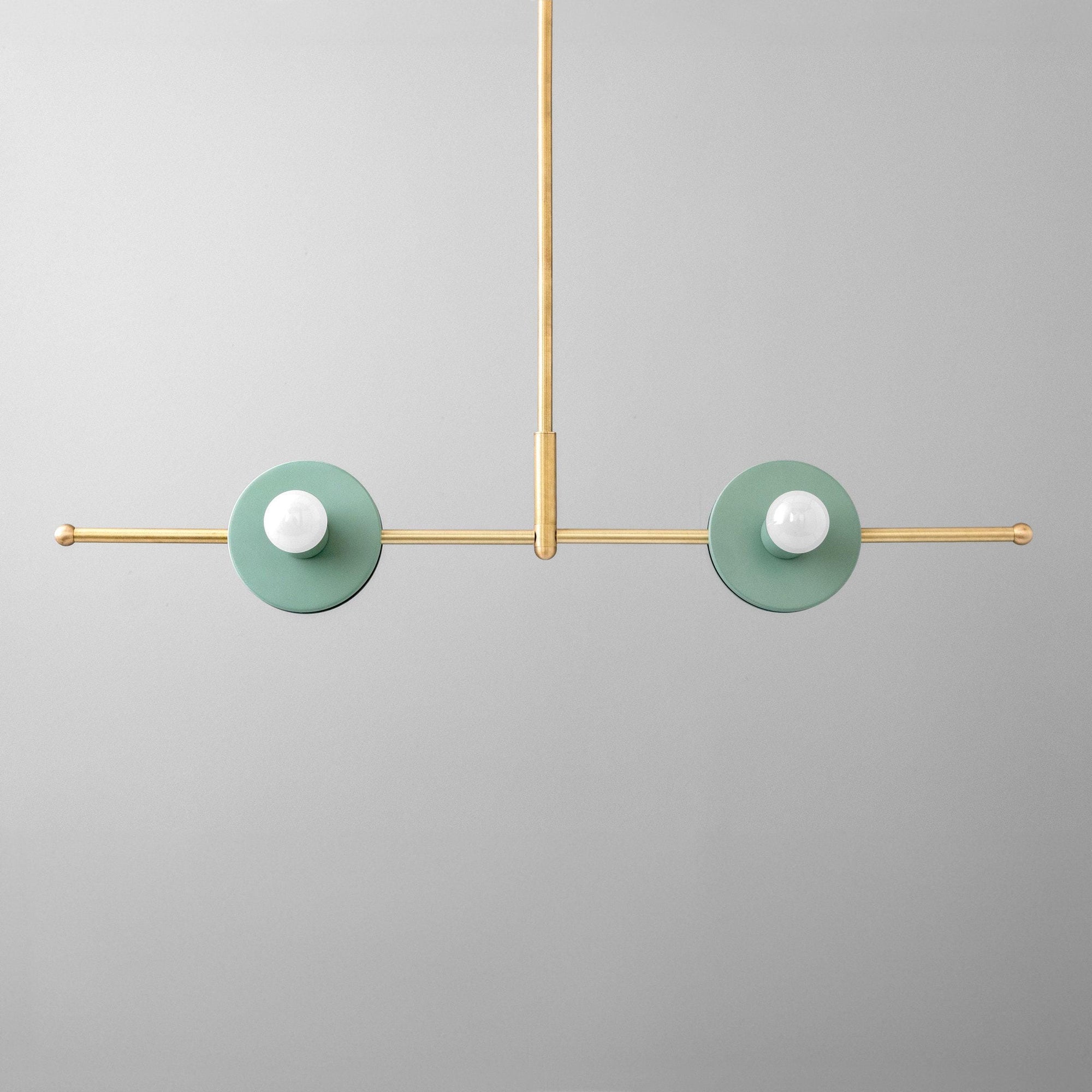 Raw brass chandelier with two green circular shades and exposed bulbs, minimalist Scandinavian design. - CHANDELIER MODEL NO. 3230