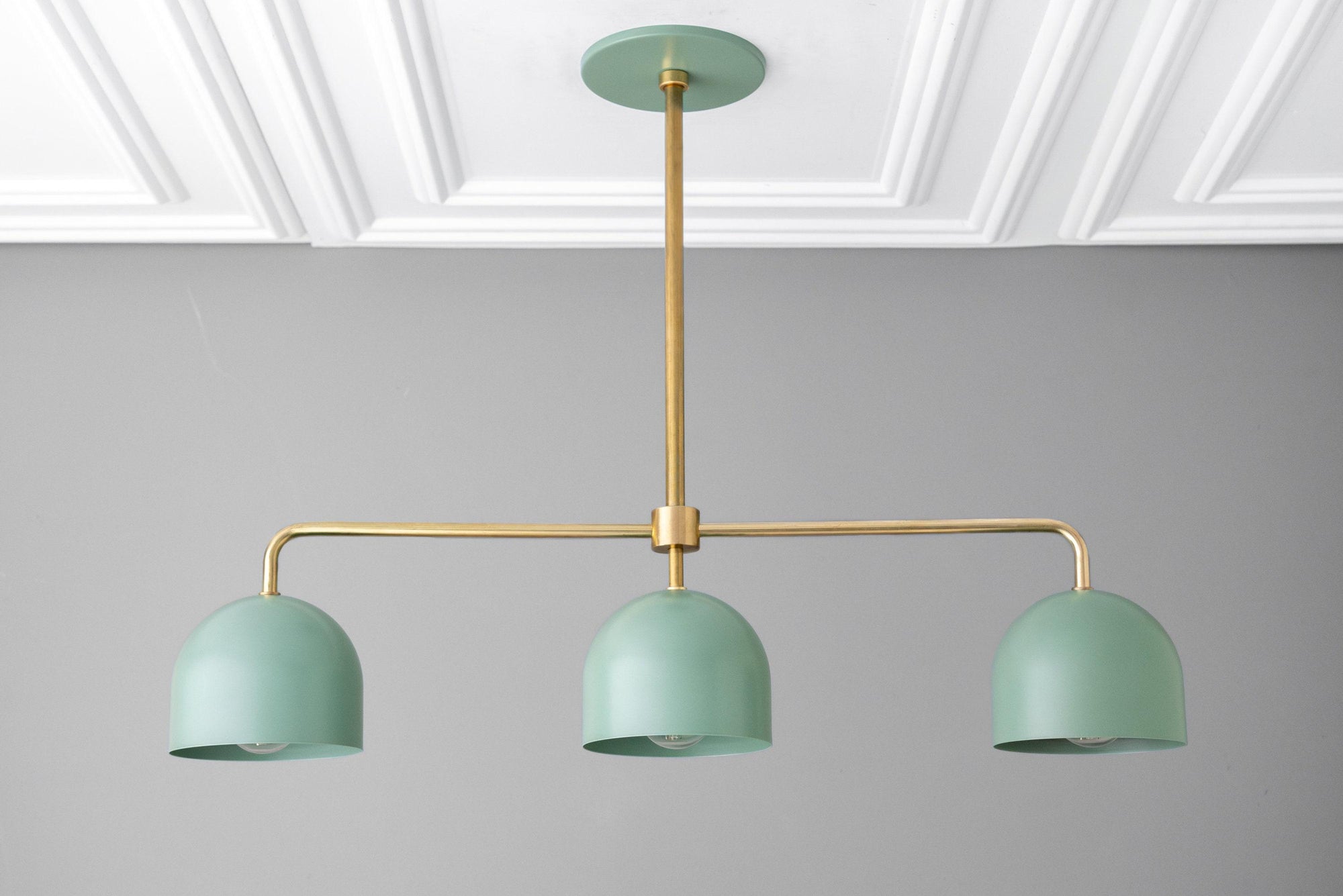 Green industrial chandelier with three dome shades and brass accents, minimalist design. - CHANDELIER MODEL NO. 0285