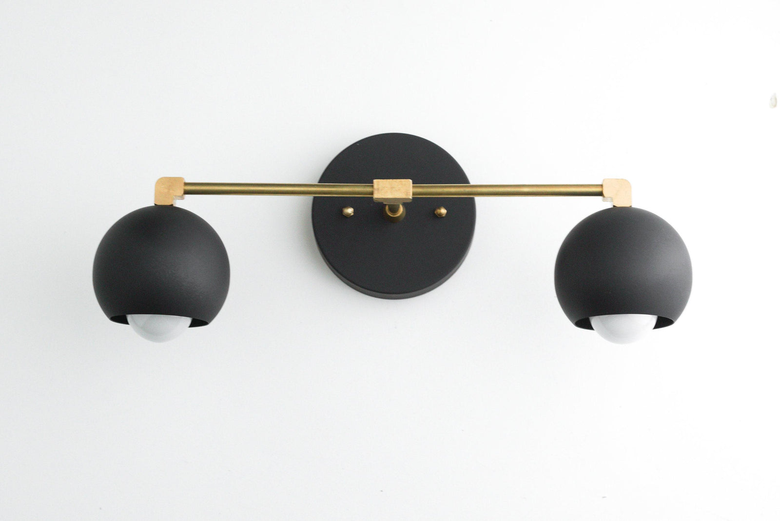 Mid-century modern black and raw brass two-bulb vanity light with spherical shades. - VANITY LIGHT MODEL NO. 5469