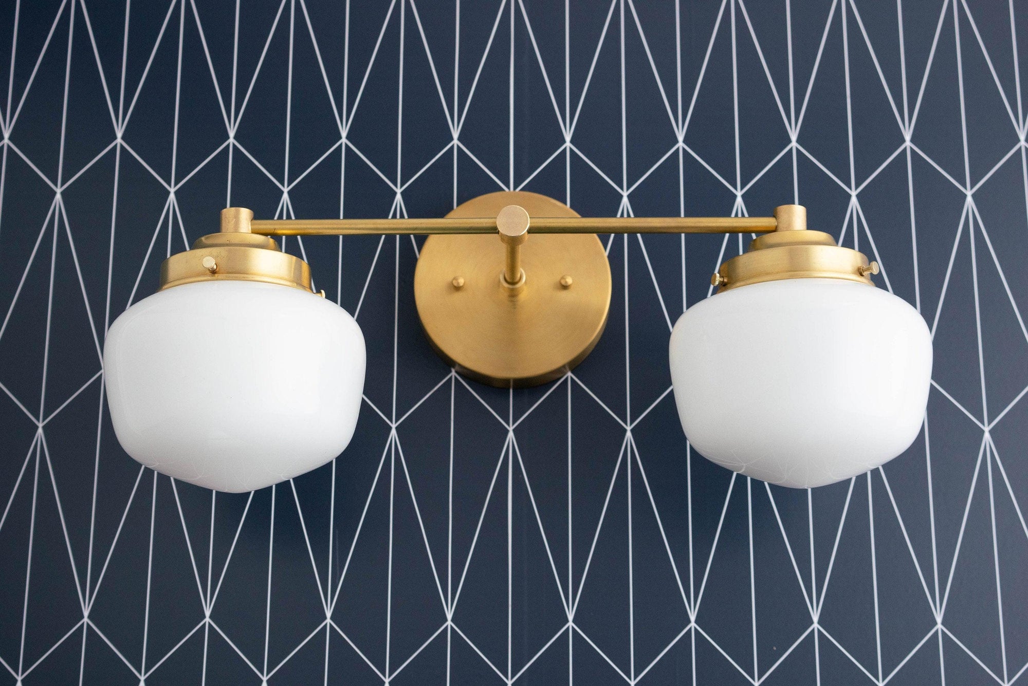 Mid-century modern 2-bulb vanity light with matte white globe shades and raw brass finish. - VANITY LIGHT MODEL NO. 5799