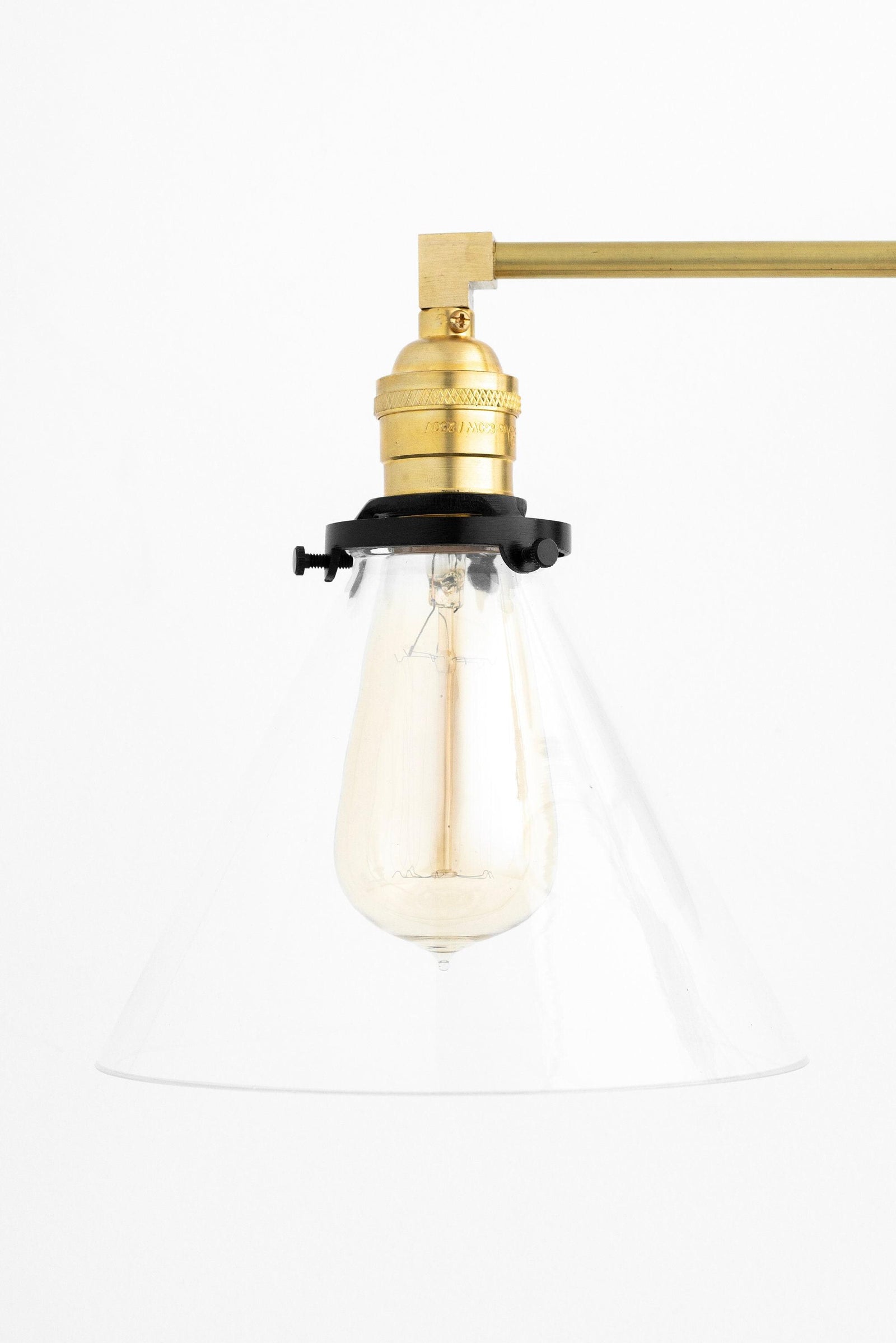 Mid-century modern vanity light with raw brass fixture and clear conical shade showcasing exposed bulb. - VANITY LIGHT MODEL NO. 5219