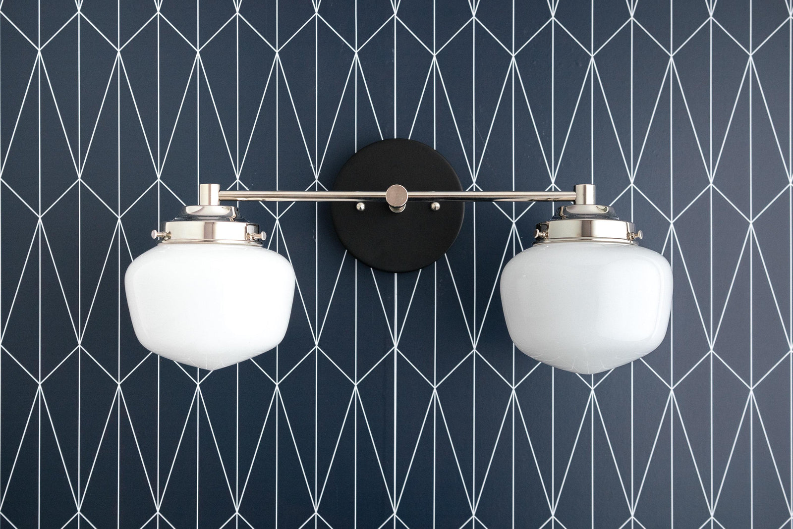 Mid-century modern two-bulb vanity light with round white glass globes and black metal accents. - VANITY LIGHT MODEL NO. 5799