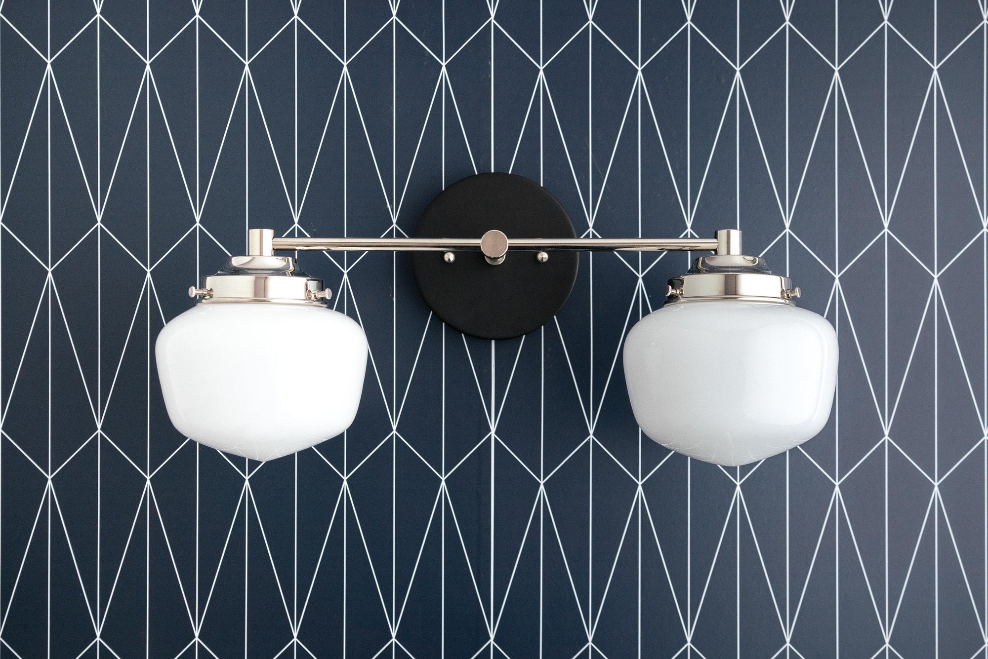 Mid-century modern two-bulb vanity light with round white glass globes and black metal accents. - VANITY LIGHT MODEL NO. 5799