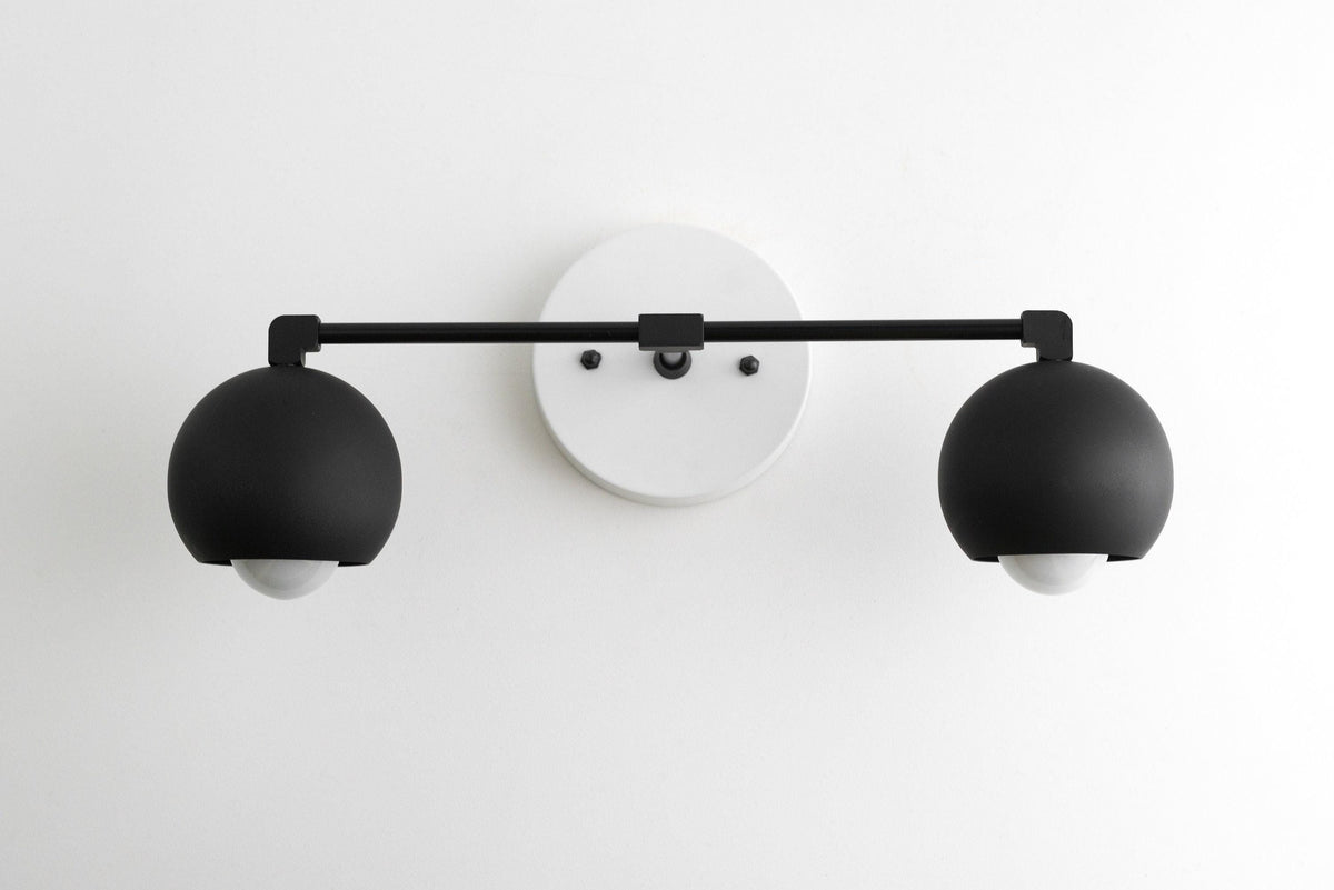 Mid-century modern black double globe vanity light with white circular wall mount. - VANITY LIGHT MODEL NO. 5469