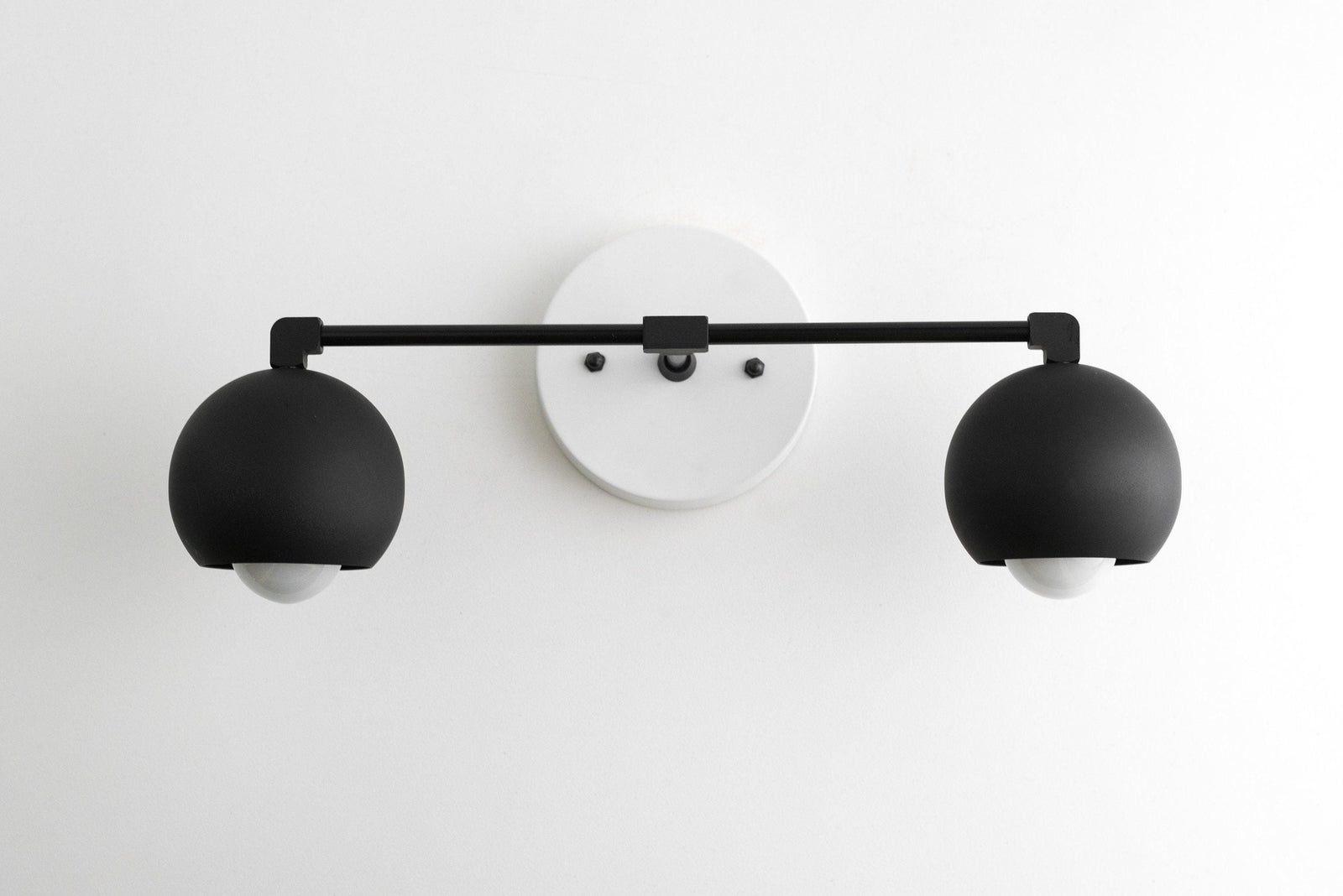 Mid-century modern black double globe vanity light with white circular wall mount. - VANITY LIGHT MODEL NO. 5469