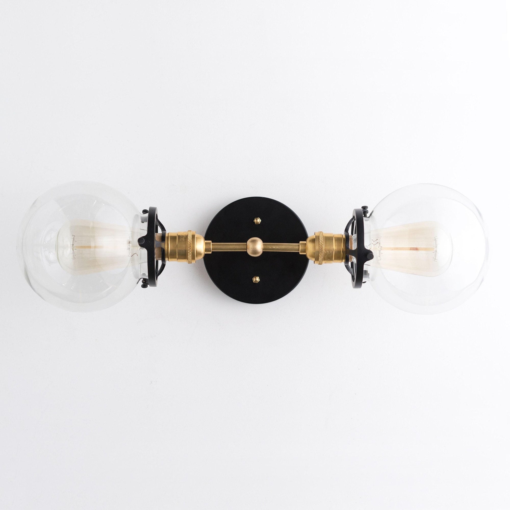 Art Deco vanity light with two clear glass globes and black and brass metal accents. - VANITY LIGHT MODEL NO. 7350