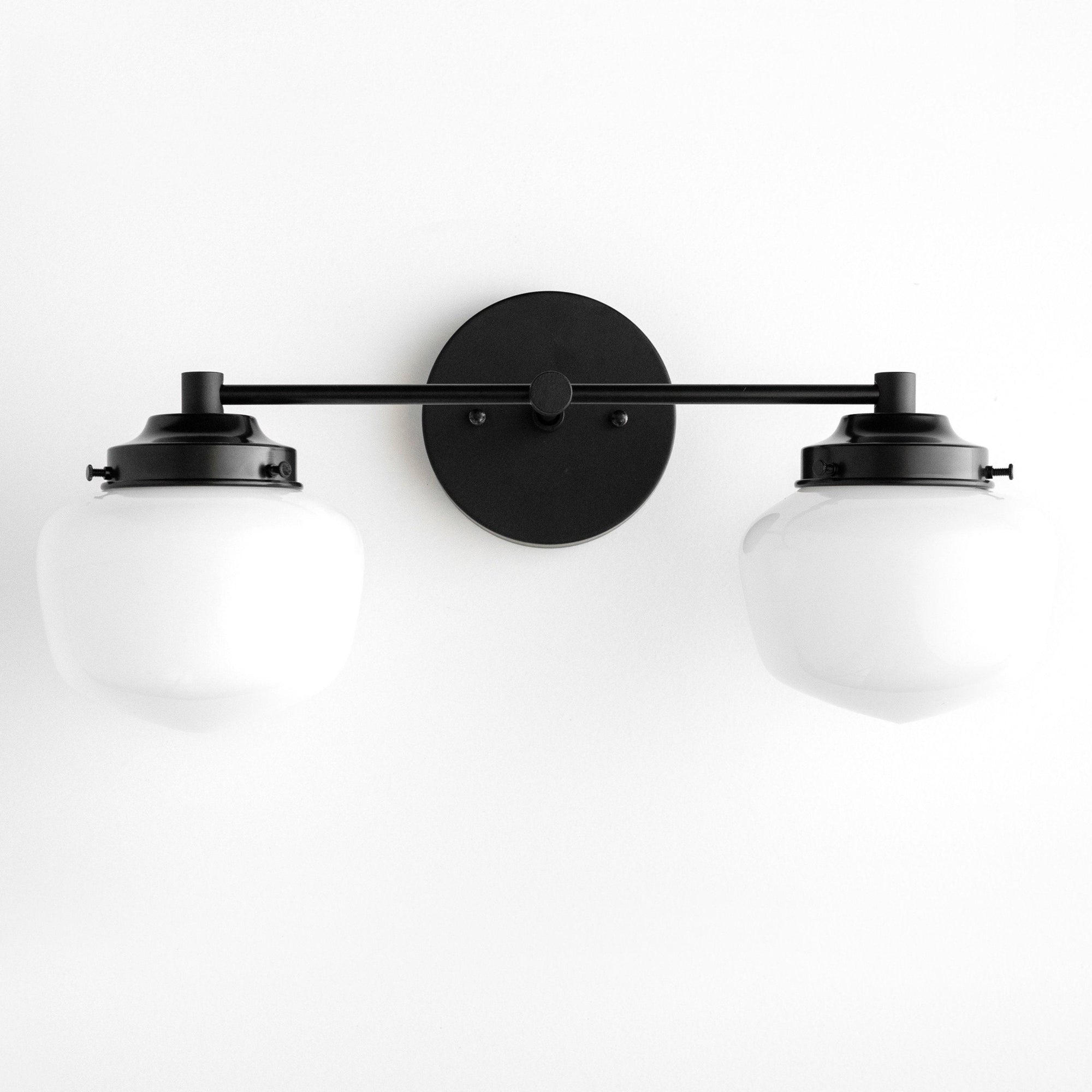 Mid-century modern black vanity light with two white glass globe bulbs and round wall mount. - VANITY LIGHT MODEL NO. 5799