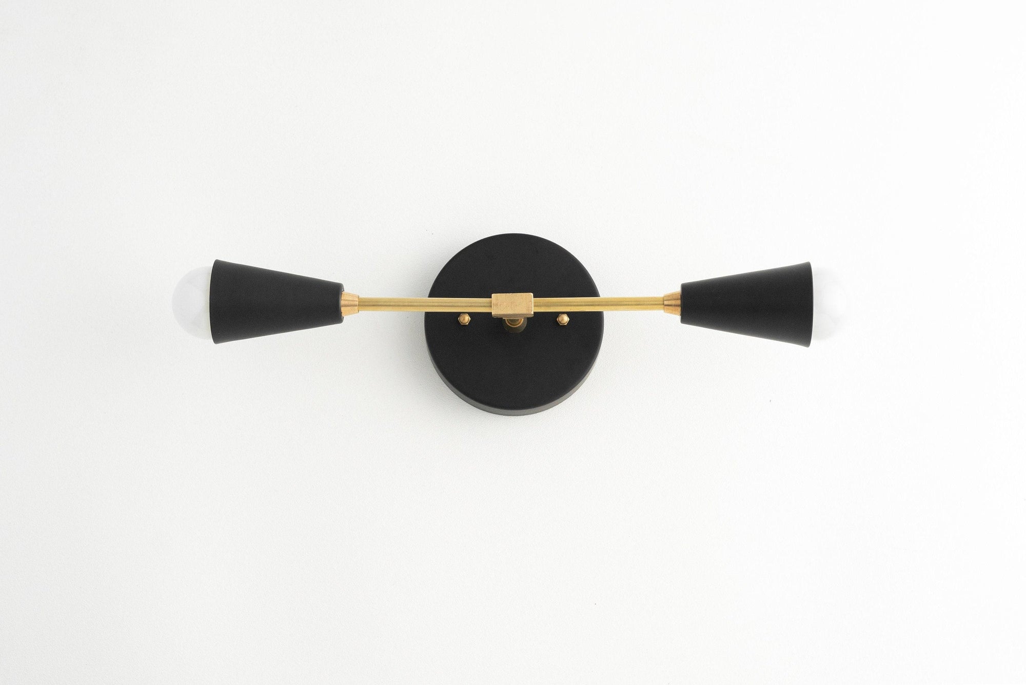 Mid-century modern 2-bulb vanity light with black conical shades and raw brass horizontal bar. - VANITY LIGHT MODEL NO. 3209