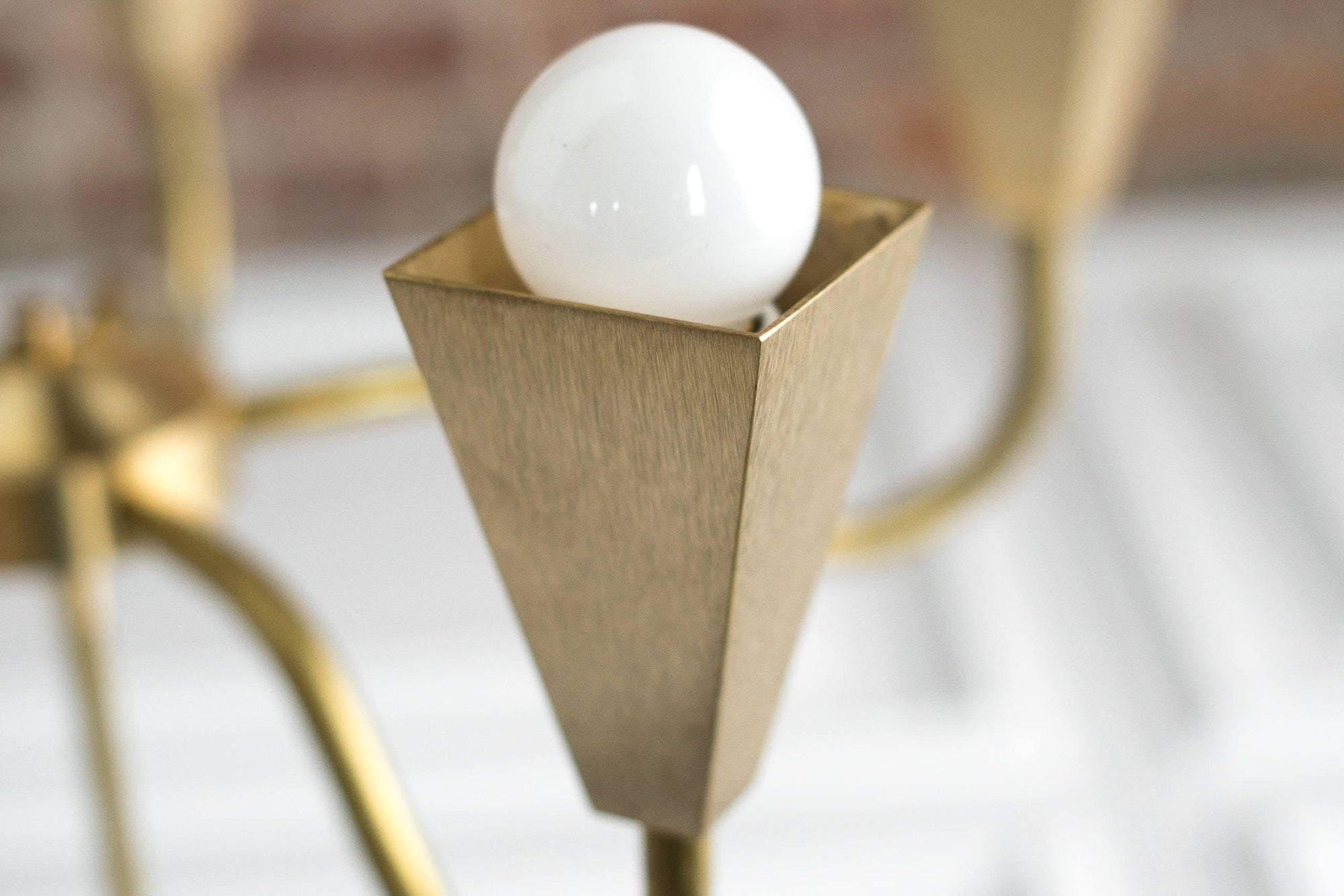 Mid-century modern raw brass chandelier arm with exposed bulb and geometric holder detail. - CHANDELIER MODEL NO. 2464