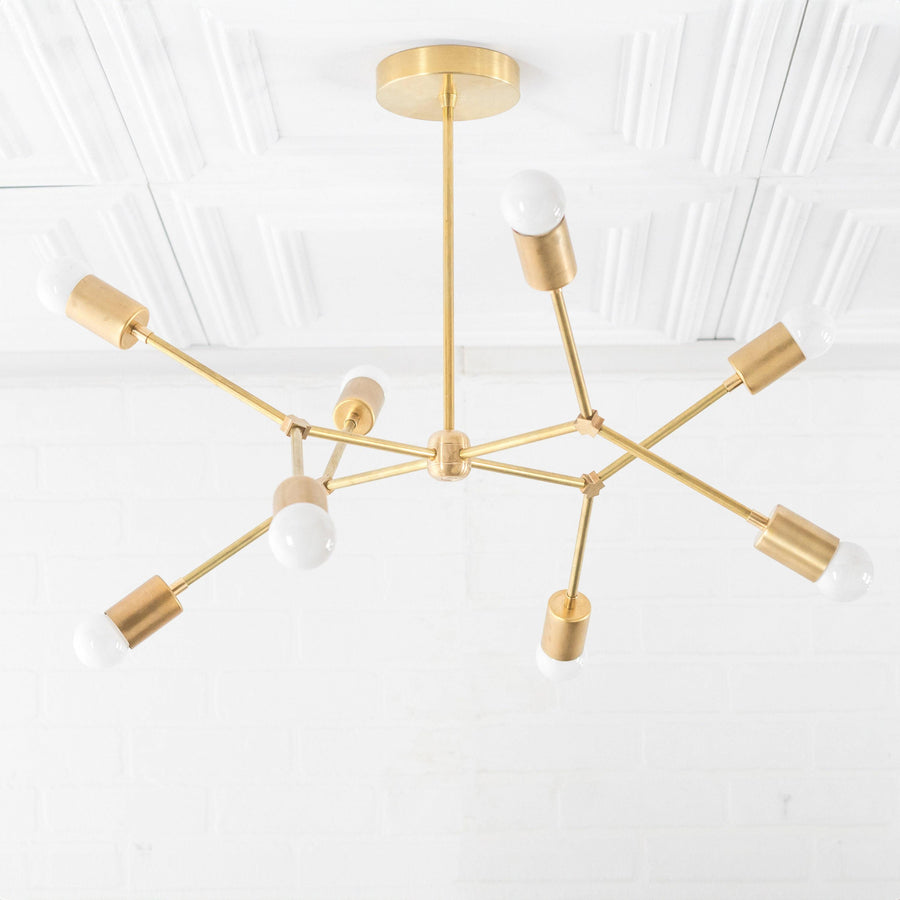 Mid-century modern raw brass chandelier with eight exposed bulbs and adjustable arms. - CHANDELIER MODEL NO. 5056