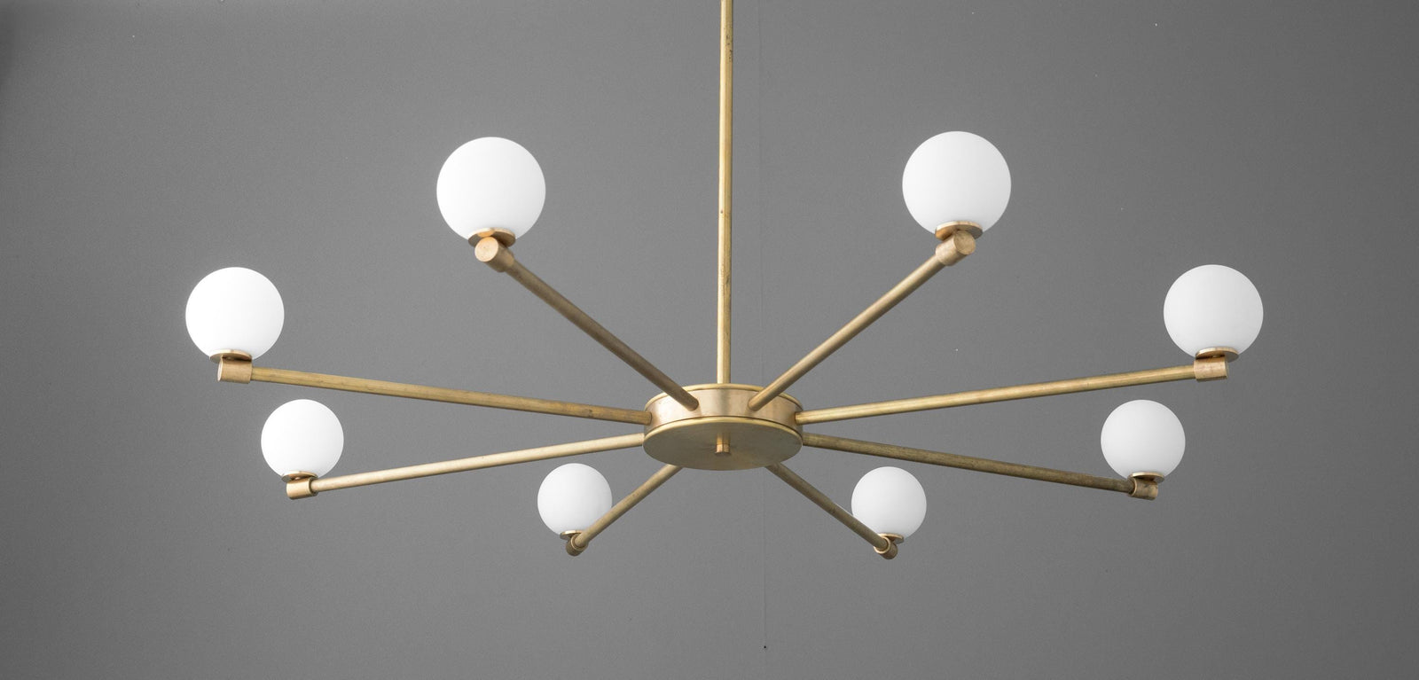Raw brass chandelier with eight globe-shaped white glass bulbs on minimalist arms. - CHANDELIER MODEL NO. 3192