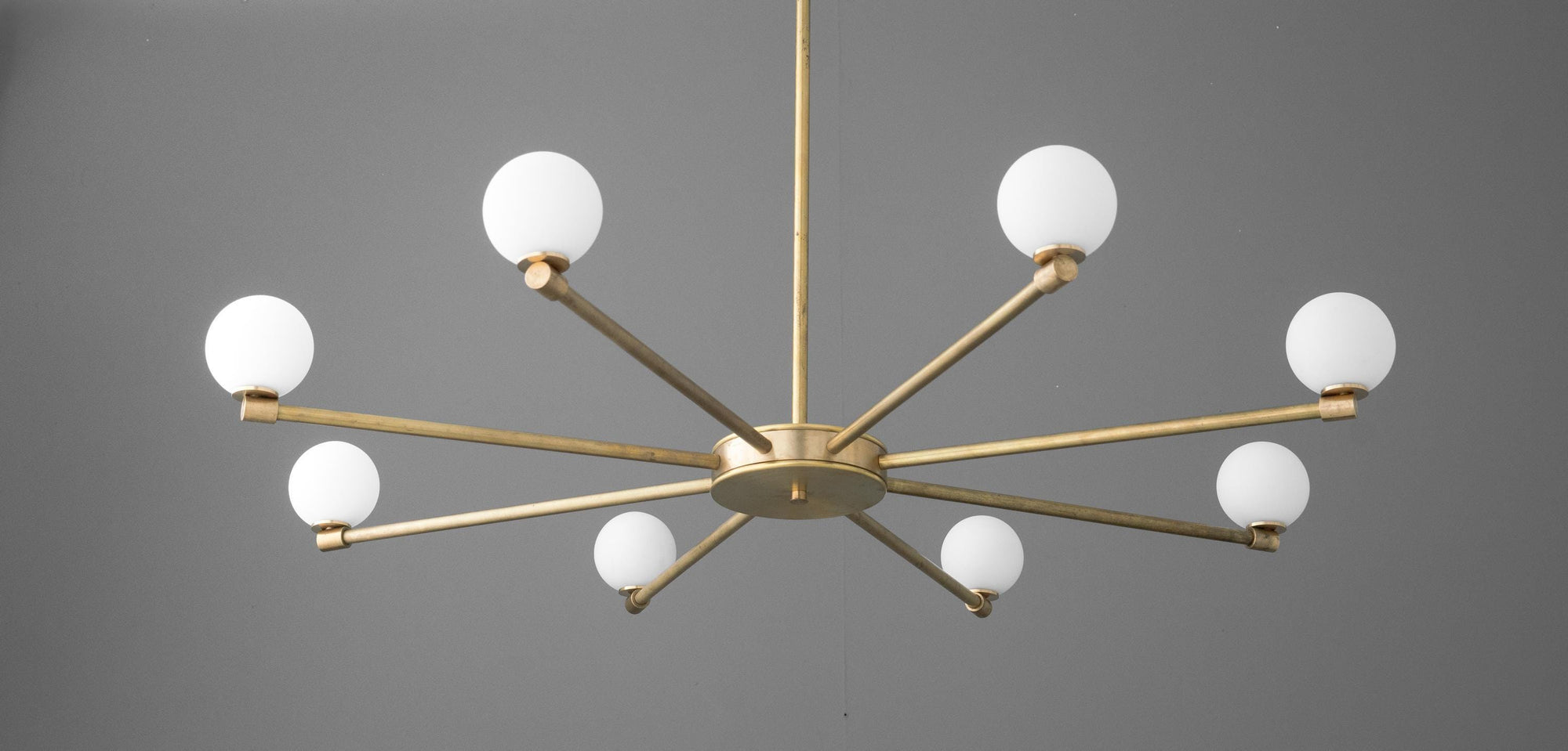 Raw brass chandelier with eight globe-shaped white glass bulbs on minimalist arms. - CHANDELIER MODEL NO. 3192