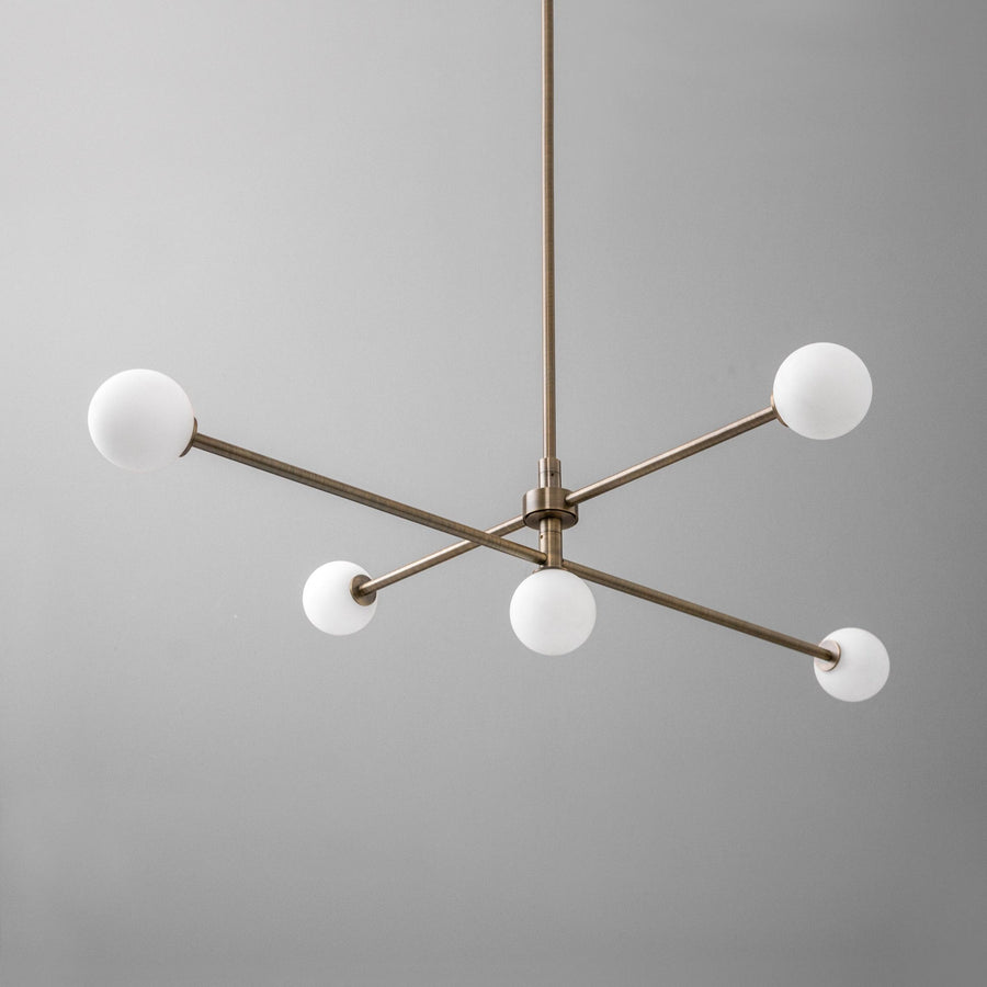 Mid-century modern brass chandelier with four white globe lights and a minimalist swivel design. - CHANDELIER MODEL NO. 4577
