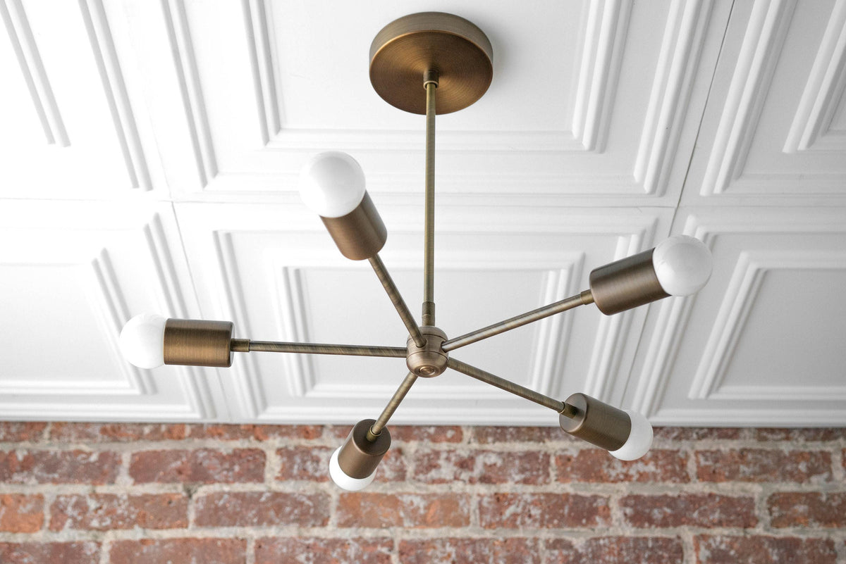 Mid-century modern chandelier with six raw brass arms and bare white bulbs suspended from ceiling mount. - CHANDELIER MODEL NO. 6652