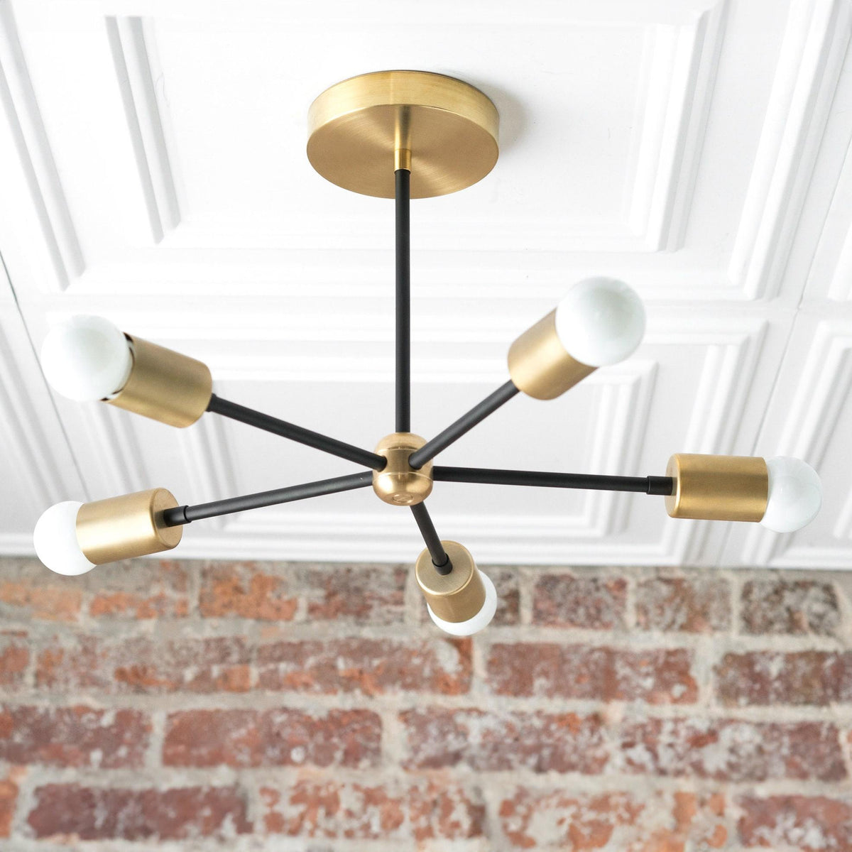 Mid-century modern chandelier with raw brass sockets and black metal arms on a brass ceiling mount. - CHANDELIER MODEL NO. 6652