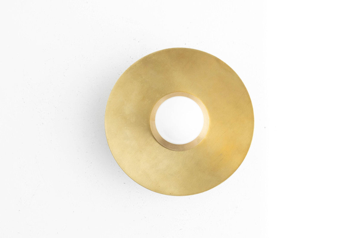 Round flush mount wall sconce in raw brass with central bare bulb design. - SCONCE MODEL NO. 7004