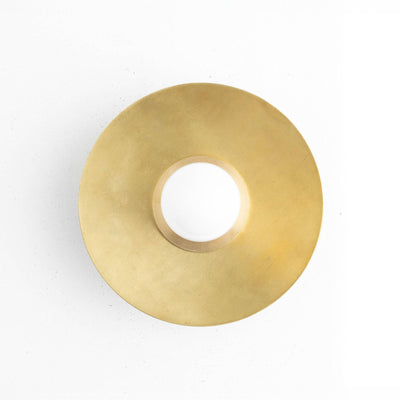 Round raw brass wall sconce with wide flat circular shade and central bare bulb opening. - SCONCE MODEL NO. 7004