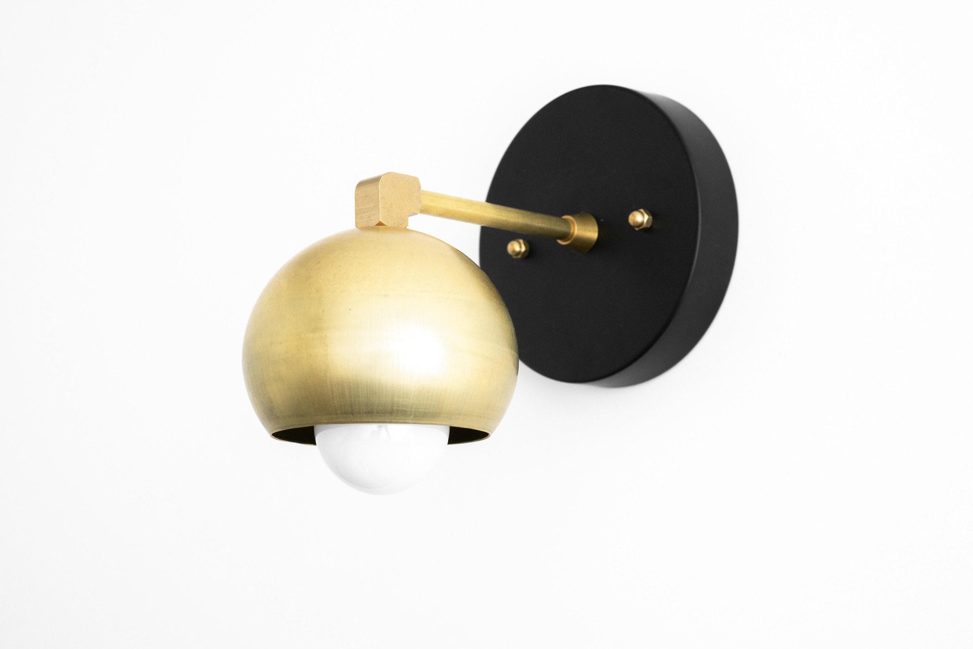 Mid-century modern sconce with raw brass dome shade and black round wall mount. - SCONCE MODEL NO. 0053