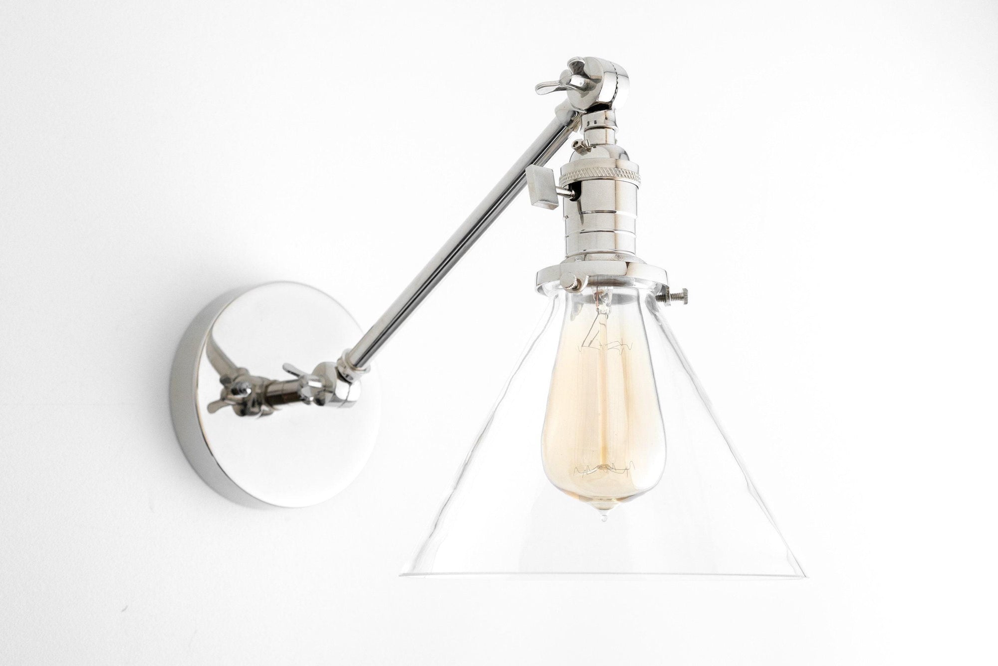 Adjustable polished nickel wall sconce with clear conical glass shade and exposed filament bulb. - SCONCE MODEL NO. 7962