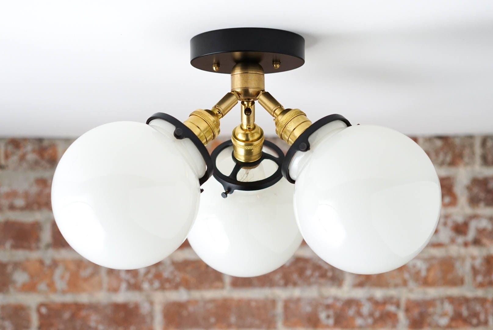 Mid-century modern flush mount ceiling light with three white glass globes and black and brass metal accents. - CEILING LIGHT MODEL NO. 0210