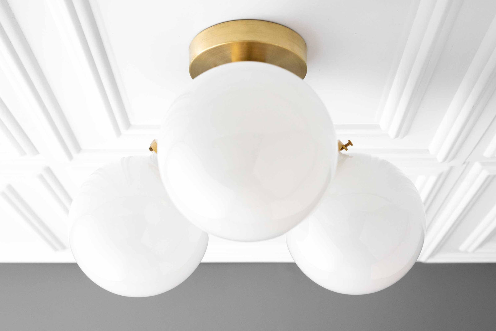 Mid-century modern flush mount ceiling light with three white glass globes and brushed brass base. - CEILING LIGHT MODEL NO. 0210