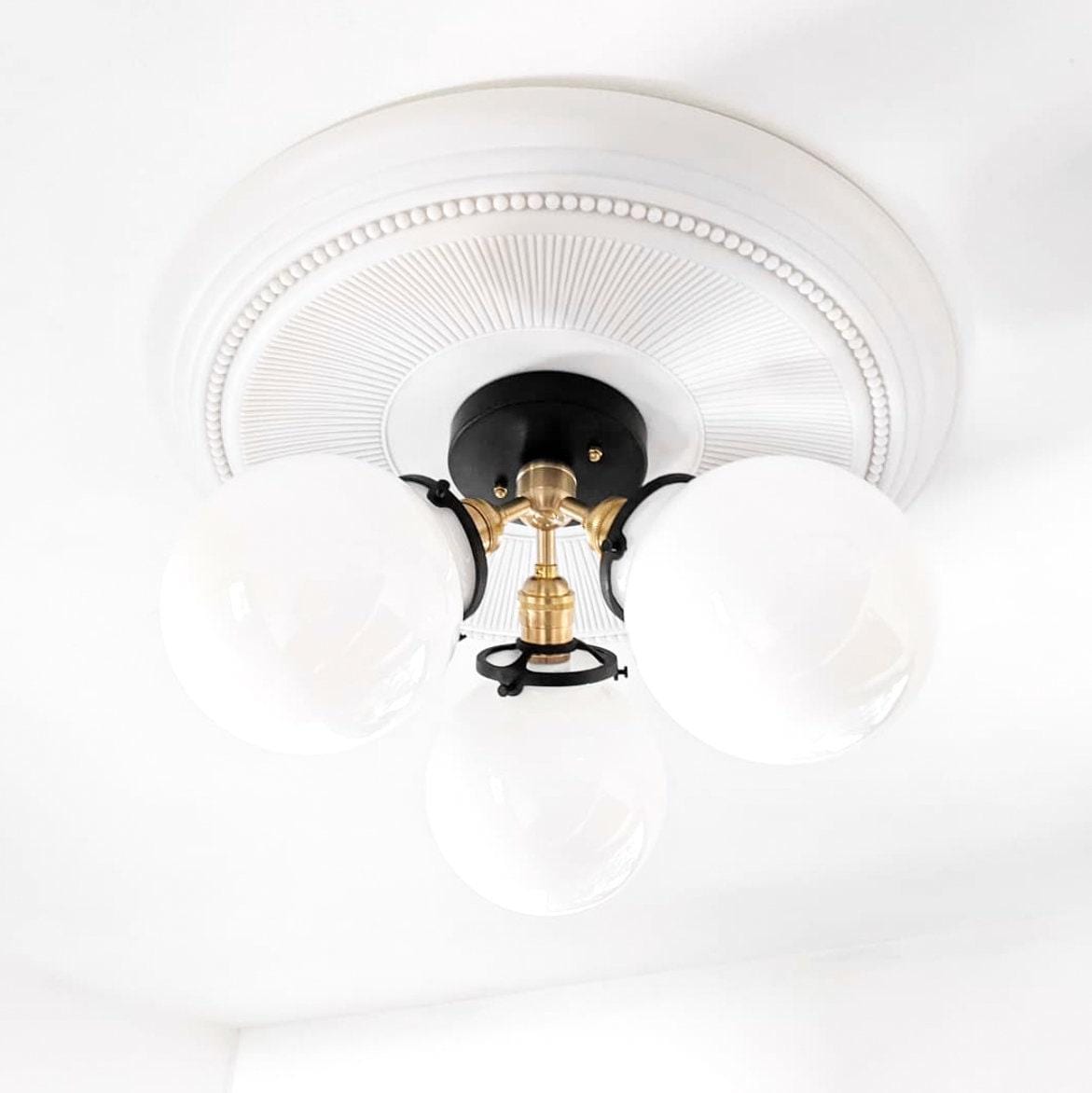Flush mount ceiling light with three white glass globes on black and brass fixture, decorative white ceiling plate. - CEILING LIGHT MODEL NO. 0210