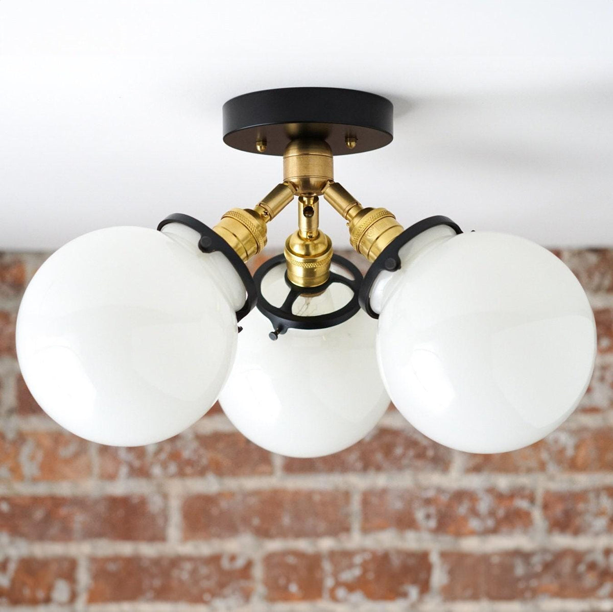 Mid-century flush mount ceiling light with three white glass globes and black and brass fixture. - CEILING LIGHT MODEL NO. 0210