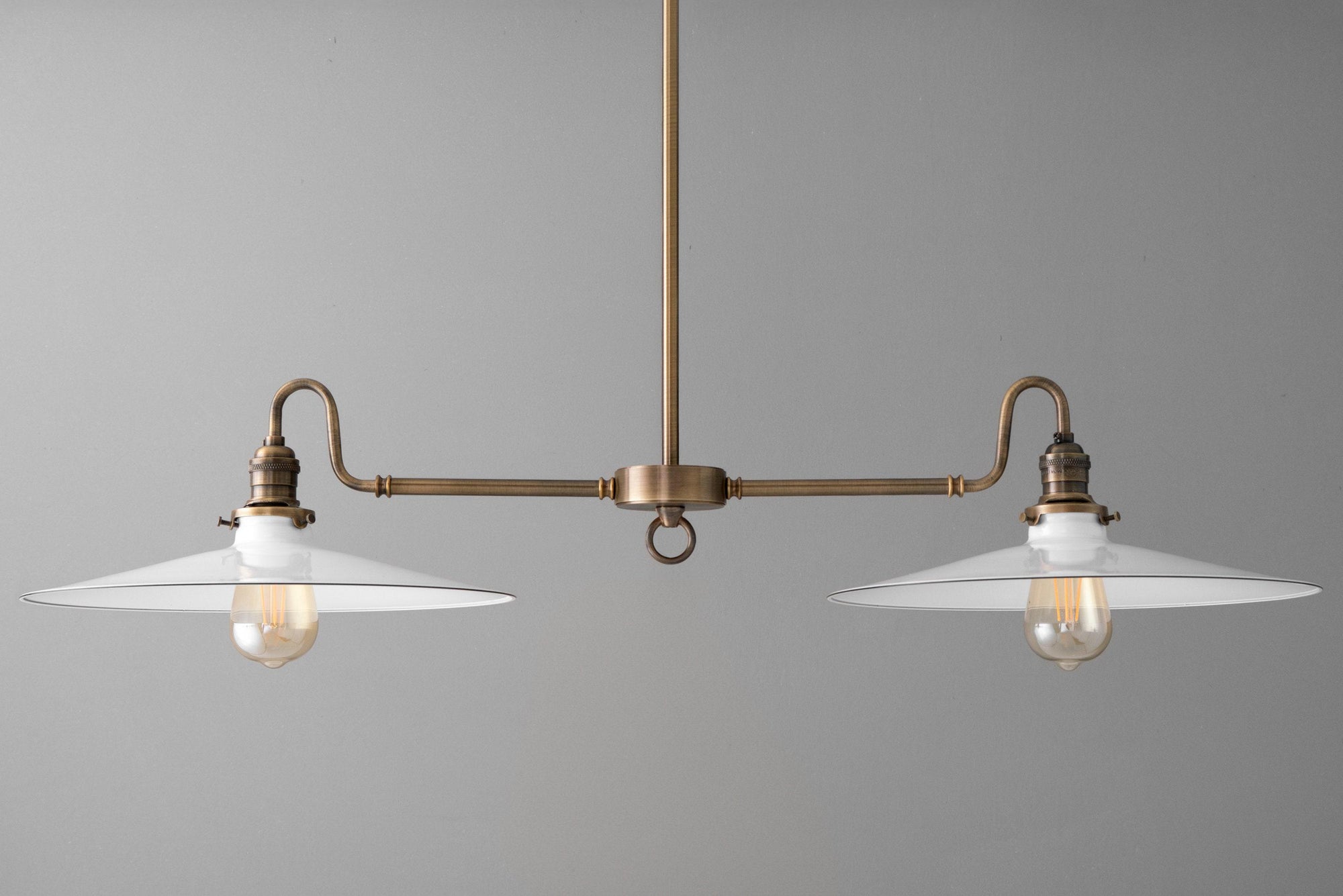 Industrial-style chandelier with antique brass finish and two white glass shades. - CHANDELIER MODEL NO. 8785
