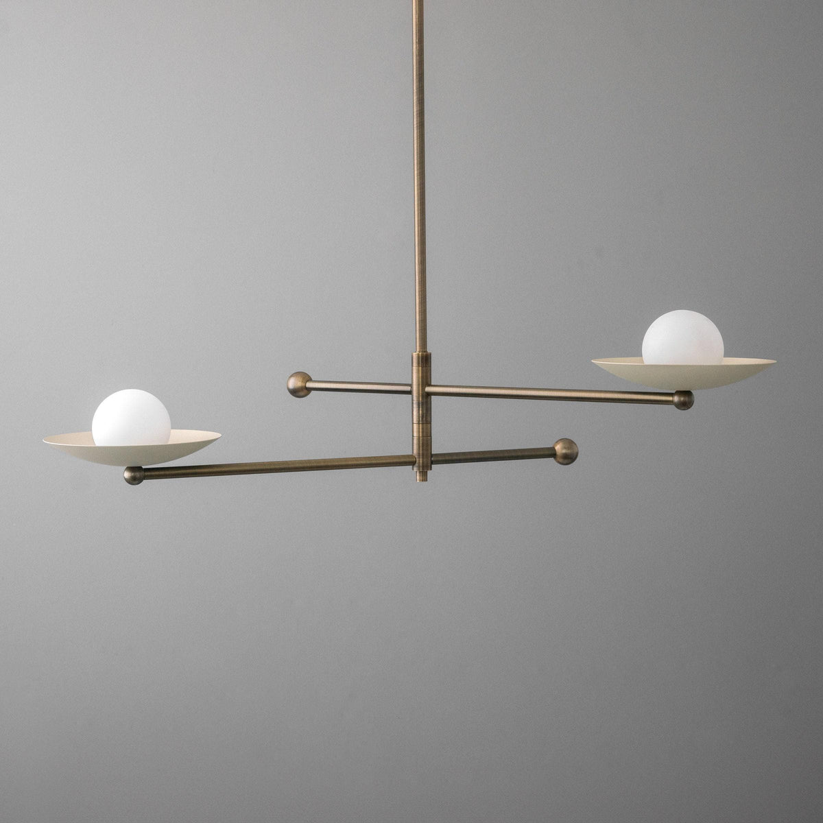 Mid-century chandelier with antique brass swivel arms and white globe shades on shallow brass trays. - CHANDELIER MODEL NO. 2933