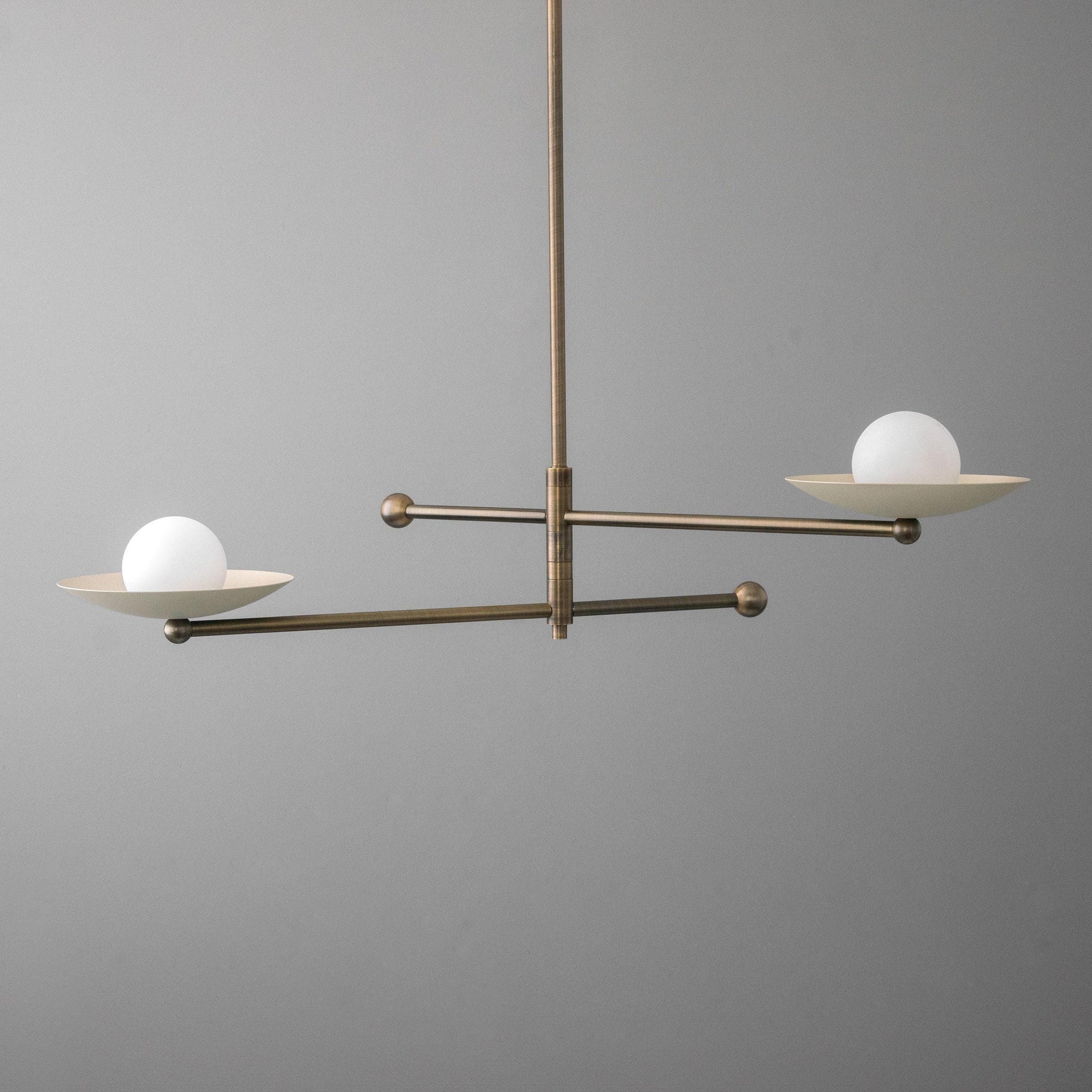 Mid-century chandelier with antique brass swivel arms and white globe shades on shallow brass trays. - CHANDELIER MODEL NO. 2933