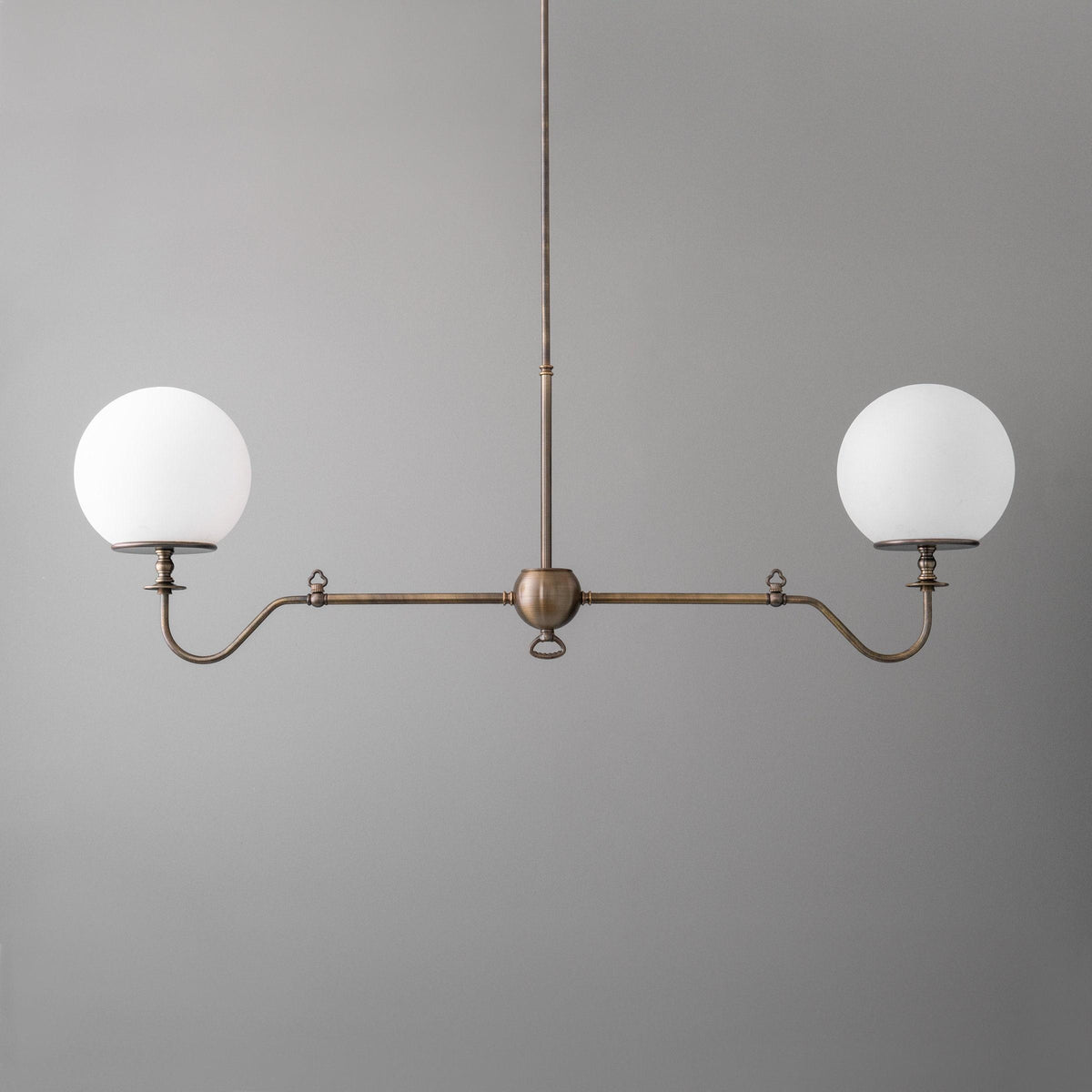 Industrial chandelier with two white glass globes and antique brass finish. - CHANDELIER MODEL NO. 5046