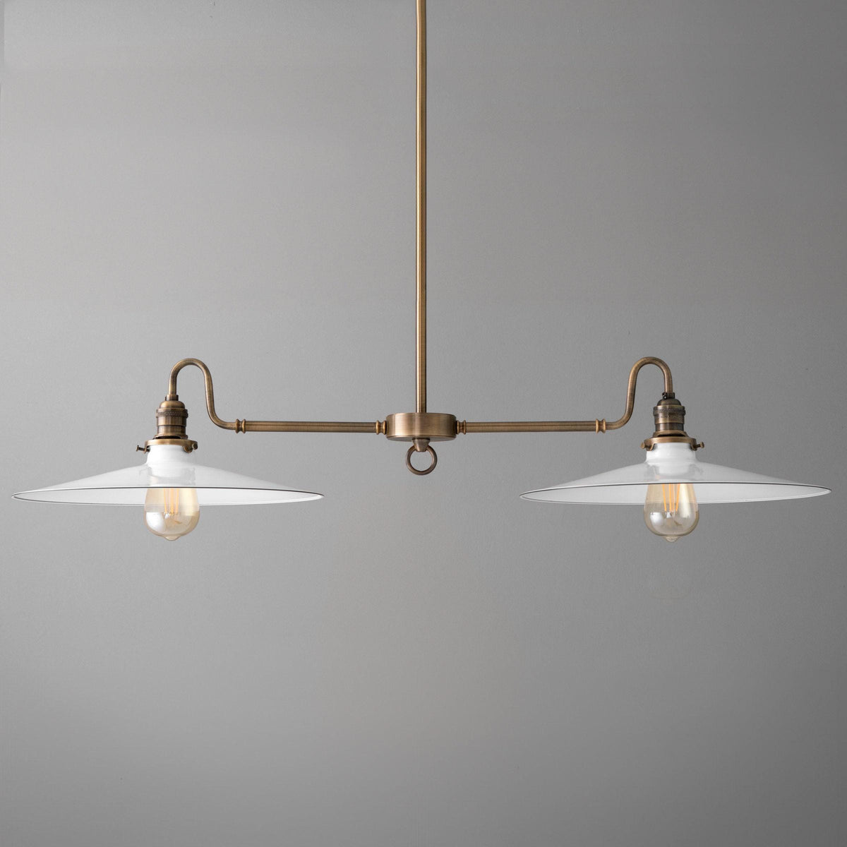 Antique brass industrial chandelier with two white metal shades and exposed bulbs. - CHANDELIER MODEL NO. 8785