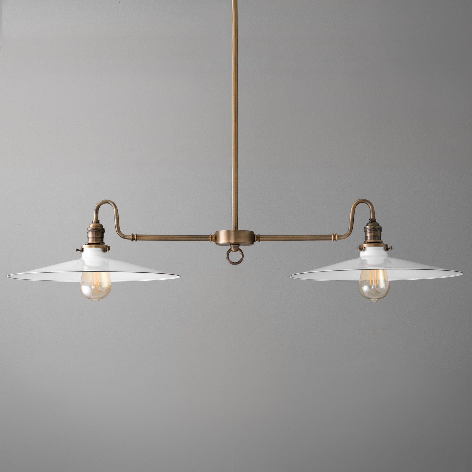 Antique brass industrial chandelier with two white metal shades and exposed bulbs. - CHANDELIER MODEL NO. 8785
