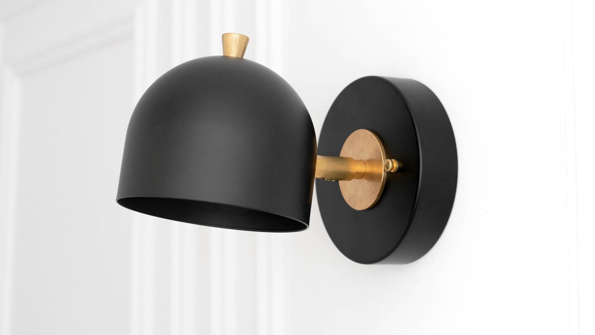 Black metal sconce with matte finish, brass accents, adjustable dome shade, Scandinavian style. - SCONCE MODEL NO. 0997