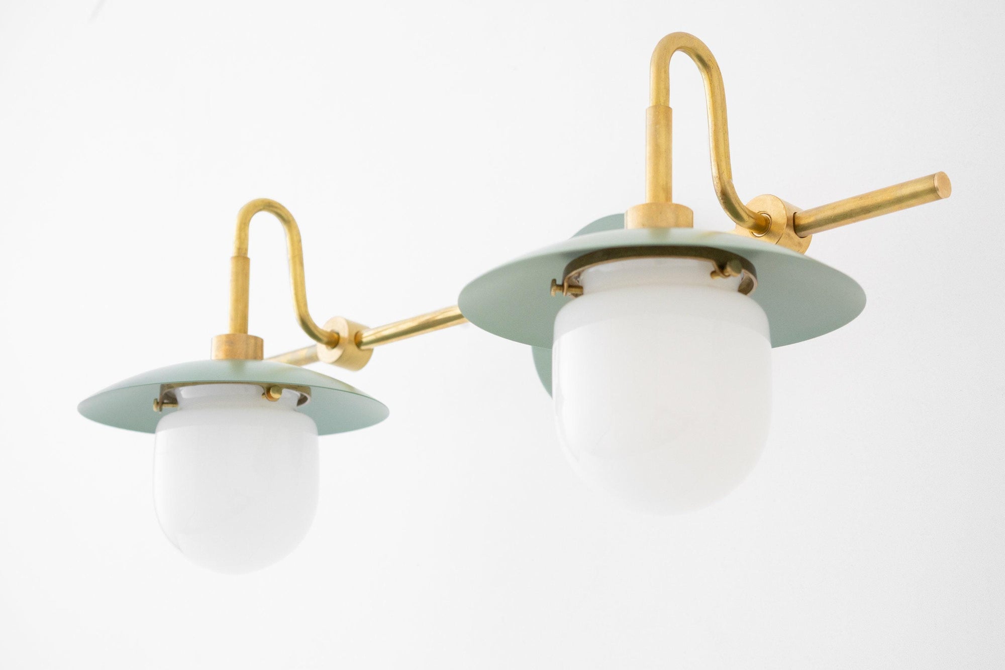 Raw brass two-bulb vanity light with frosted glass globes and sage green metal shades. - VANITY LIGHT MODEL NO. 0347