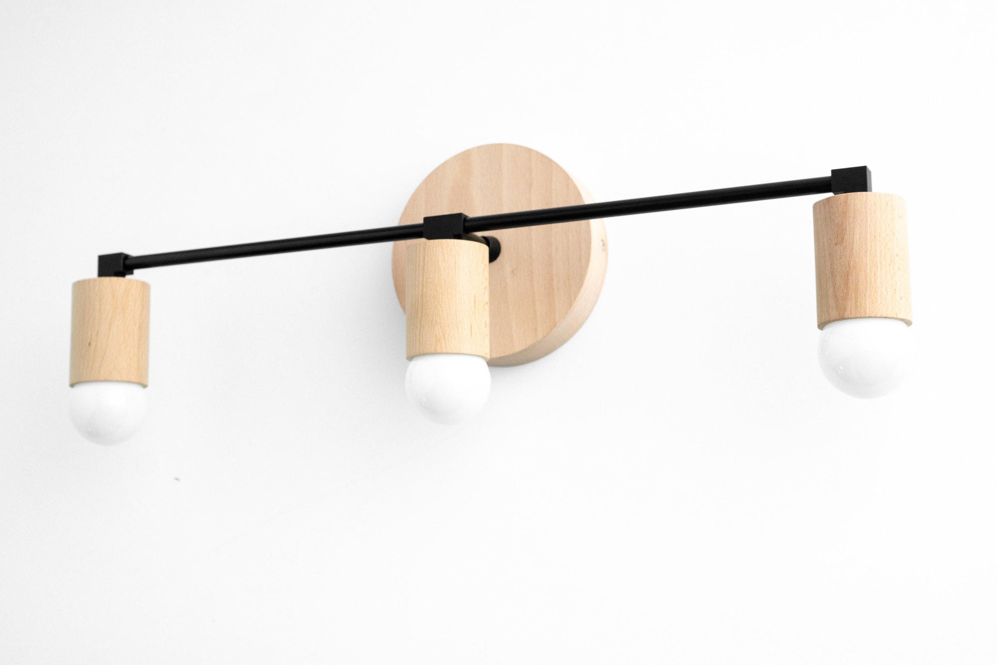 Modern 3-bulb vanity light with natural beech wood and black metal accents. - VANITY LIGHT MODEL NO. 4446