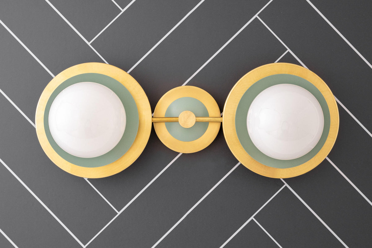 Mid-century modern raw brass vanity light with two green globe bulbs and circular wall mount. - VANITY LIGHT MODEL NO. 9361