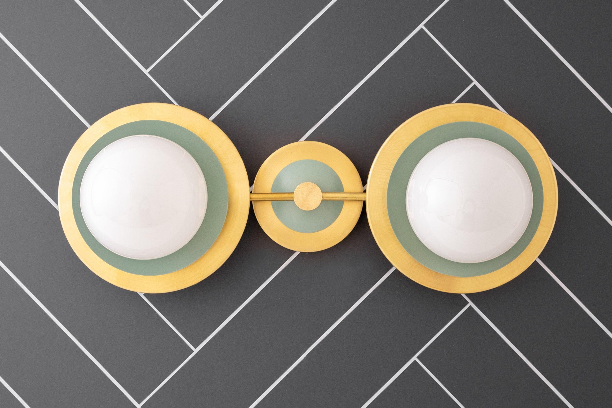 Mid-century modern raw brass vanity light with two green globe bulbs and circular wall mount. - VANITY LIGHT MODEL NO. 9361