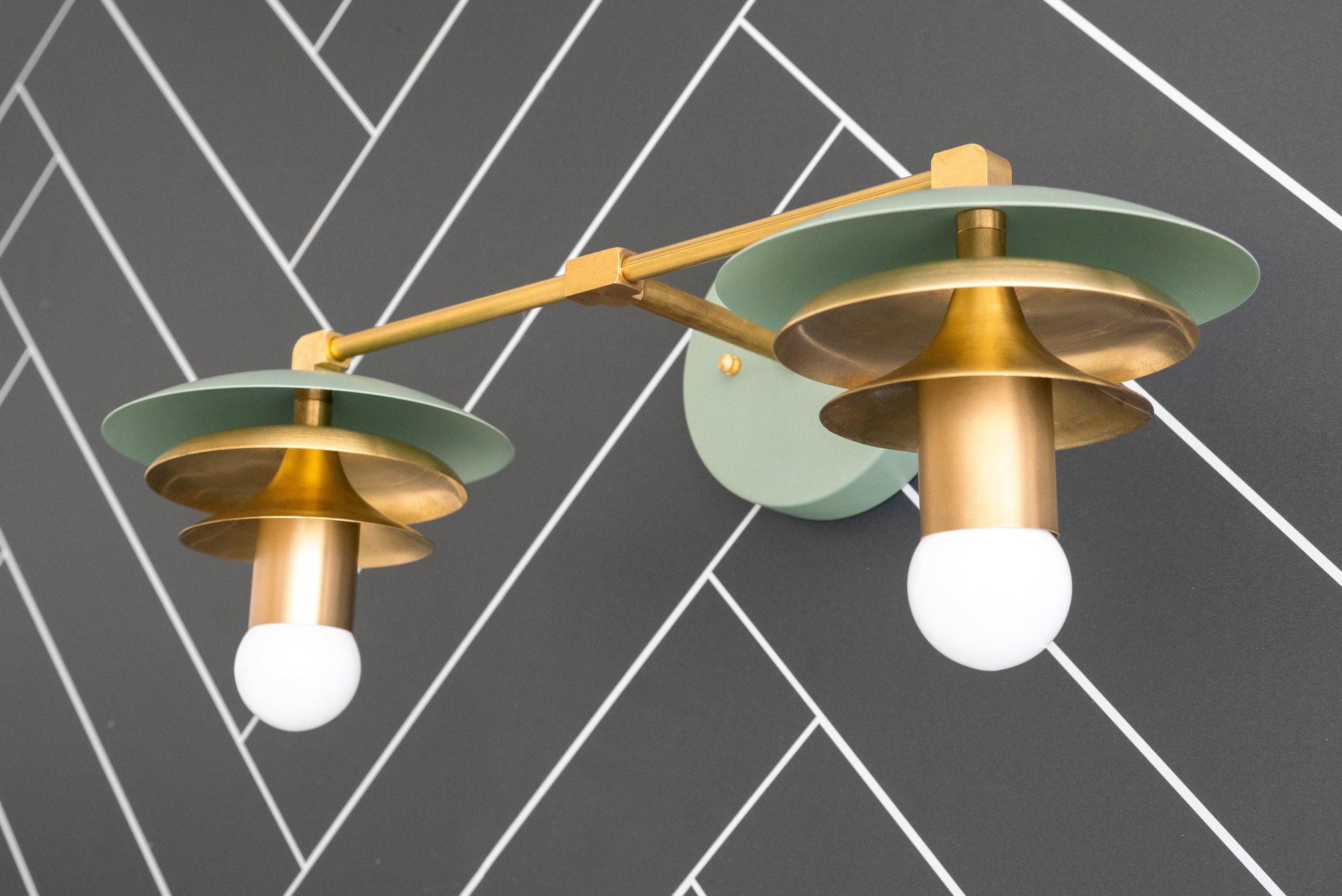 Raw brass dual-bulb vanity light with green circular shades and Art Deco design. - VANITY LIGHT MODEL NO. 5806