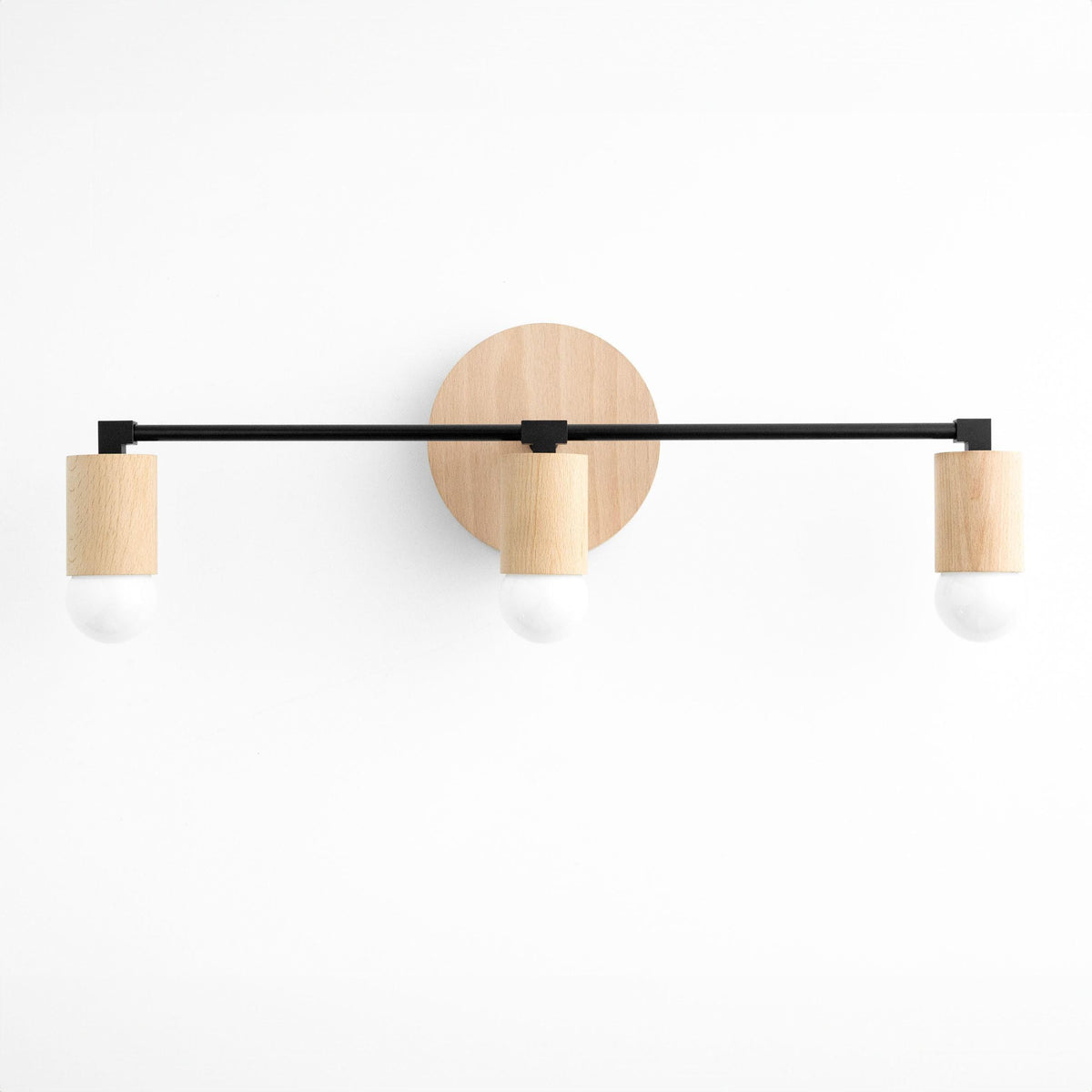 Three-bulb vanity light with black metal bar and natural beech wood bulb holders on round wood base. - VANITY LIGHT MODEL NO. 4446