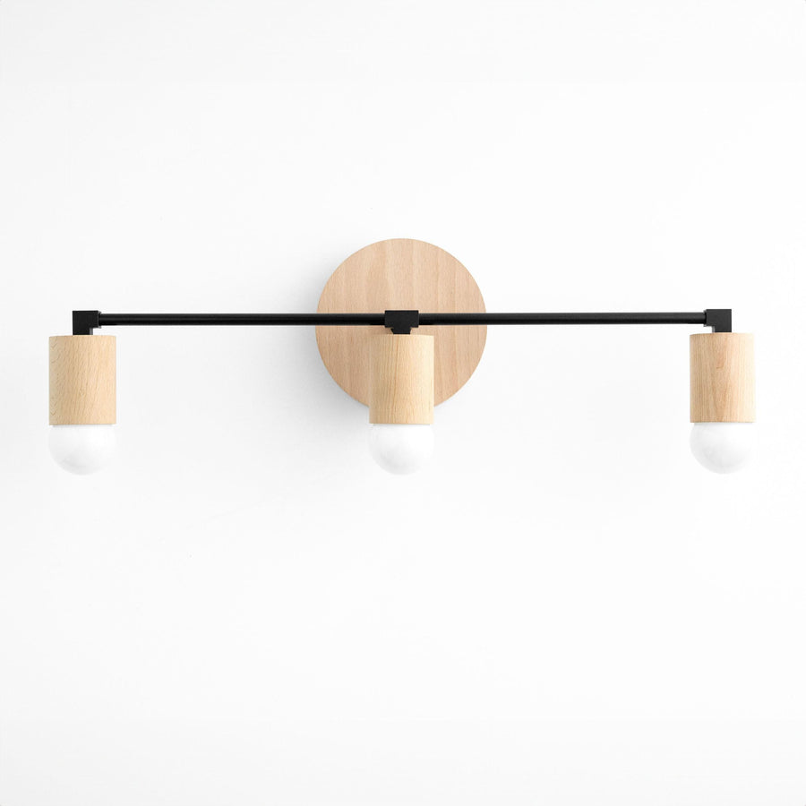 Three-bulb vanity light with black metal bar and natural beech wood bulb holders on round wood base. - VANITY LIGHT MODEL NO. 4446