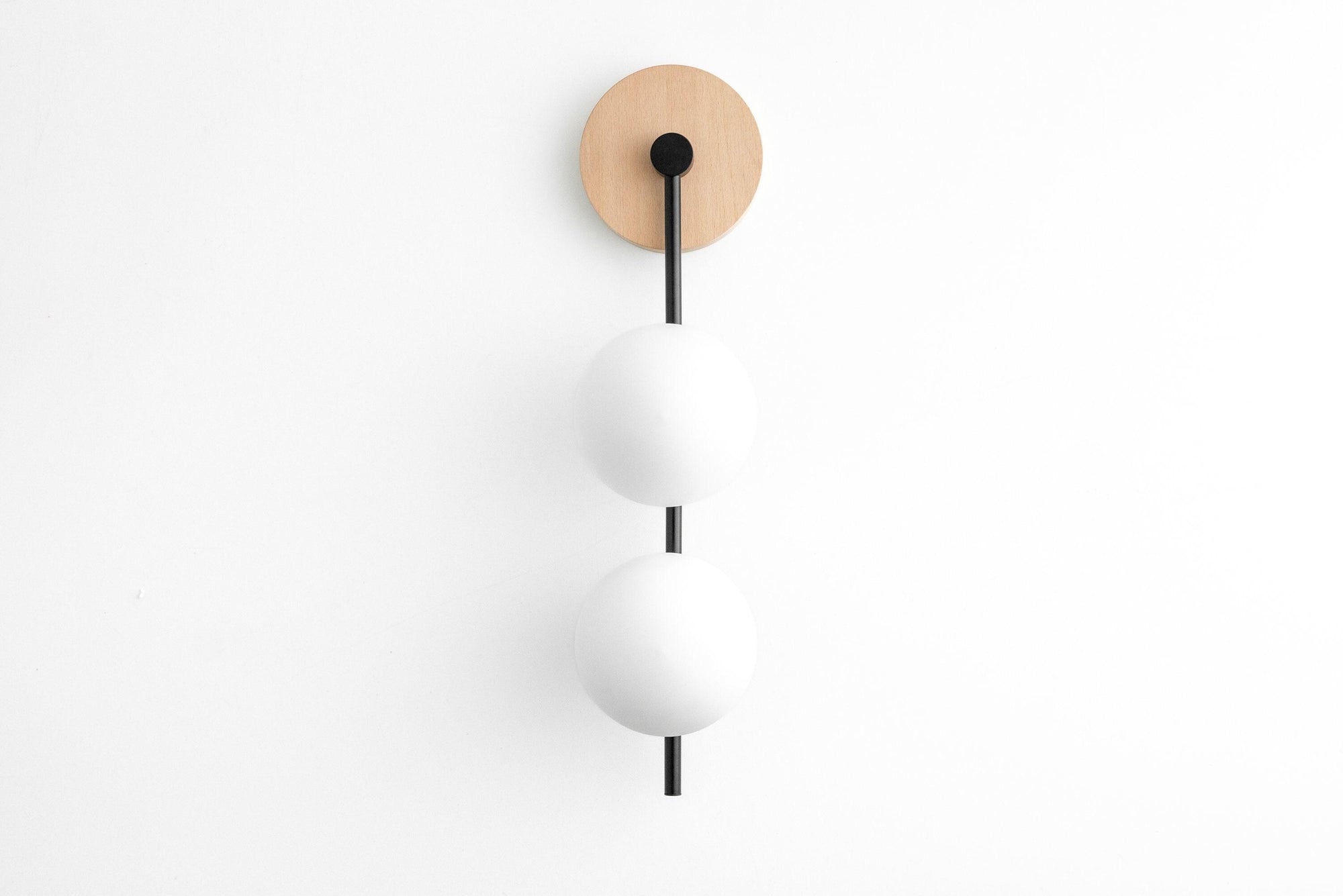 Mid-century modern drop sconce with two frosted glass globes and beechwood wall mount. - SCONCE MODEL NO. 0344