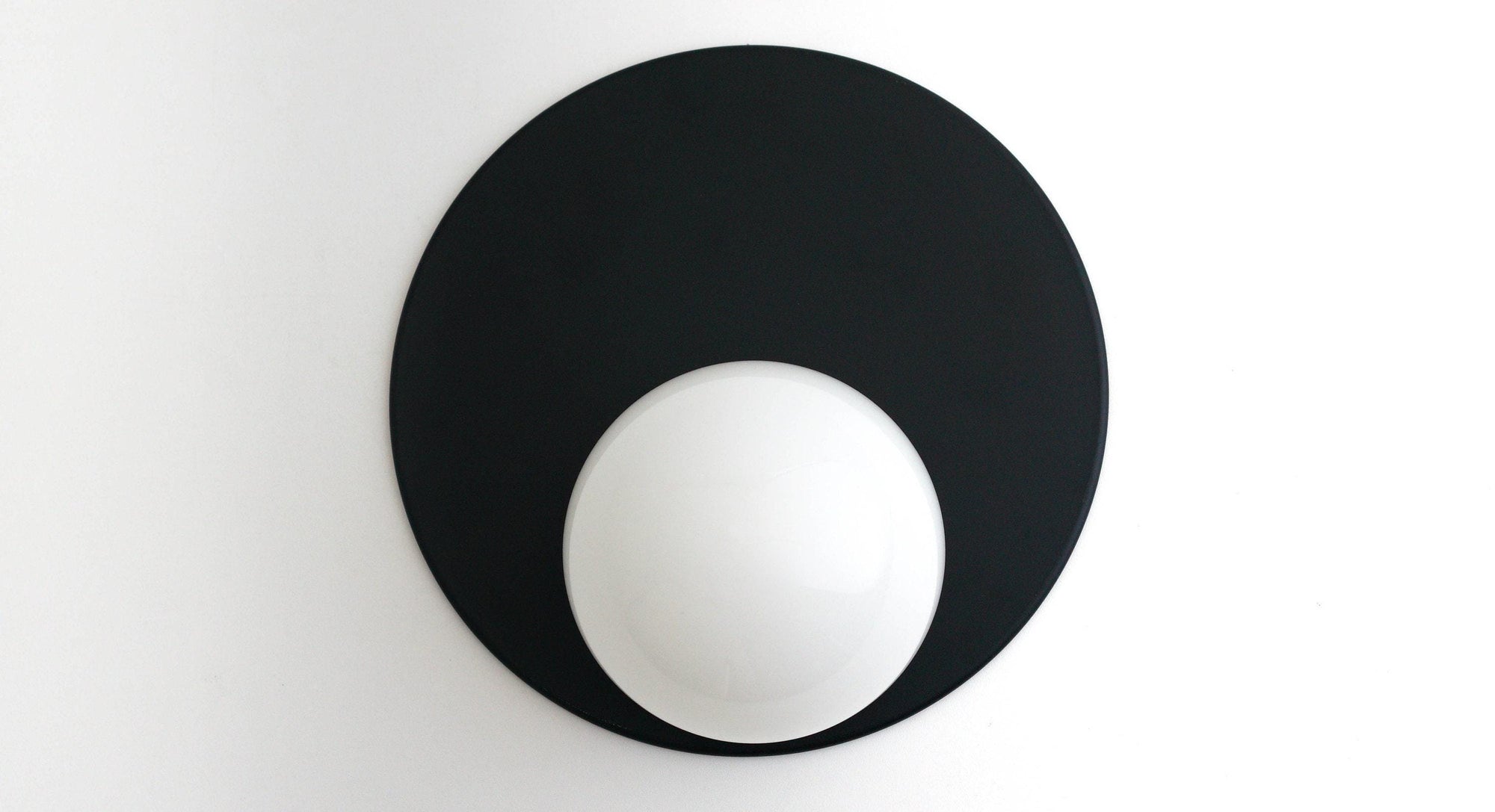 Black mid-century modern wall sconce with a round white glass globe and circular backplate. - SCONCE MODEL NO. 6703