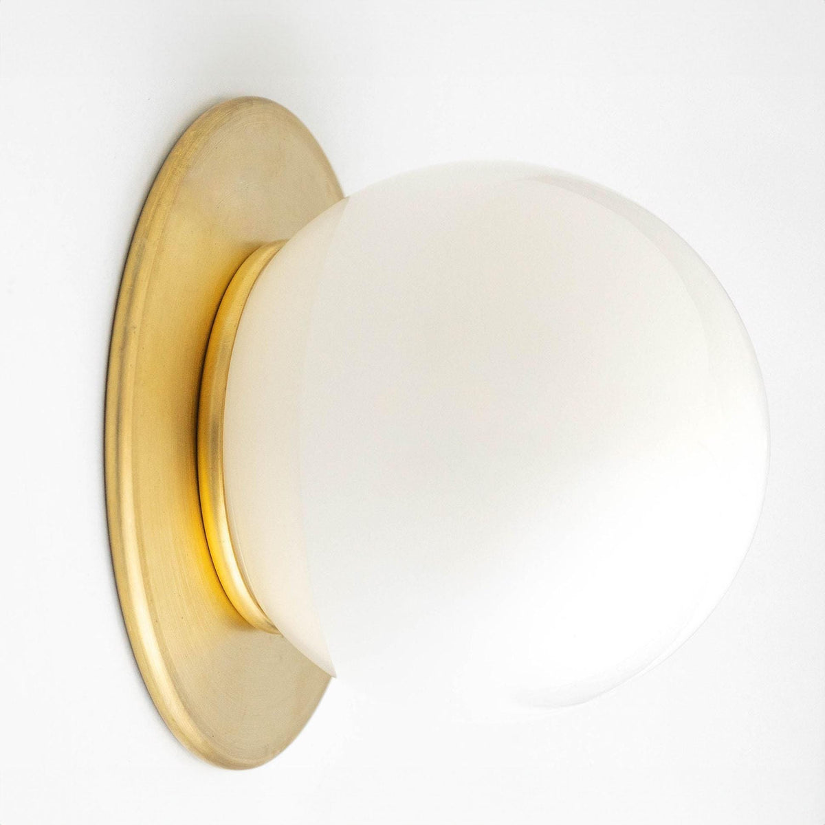 Mid-century modern wall sconce with raw brass base and white frosted glass globe. - SCONCE MODEL NO. 9364