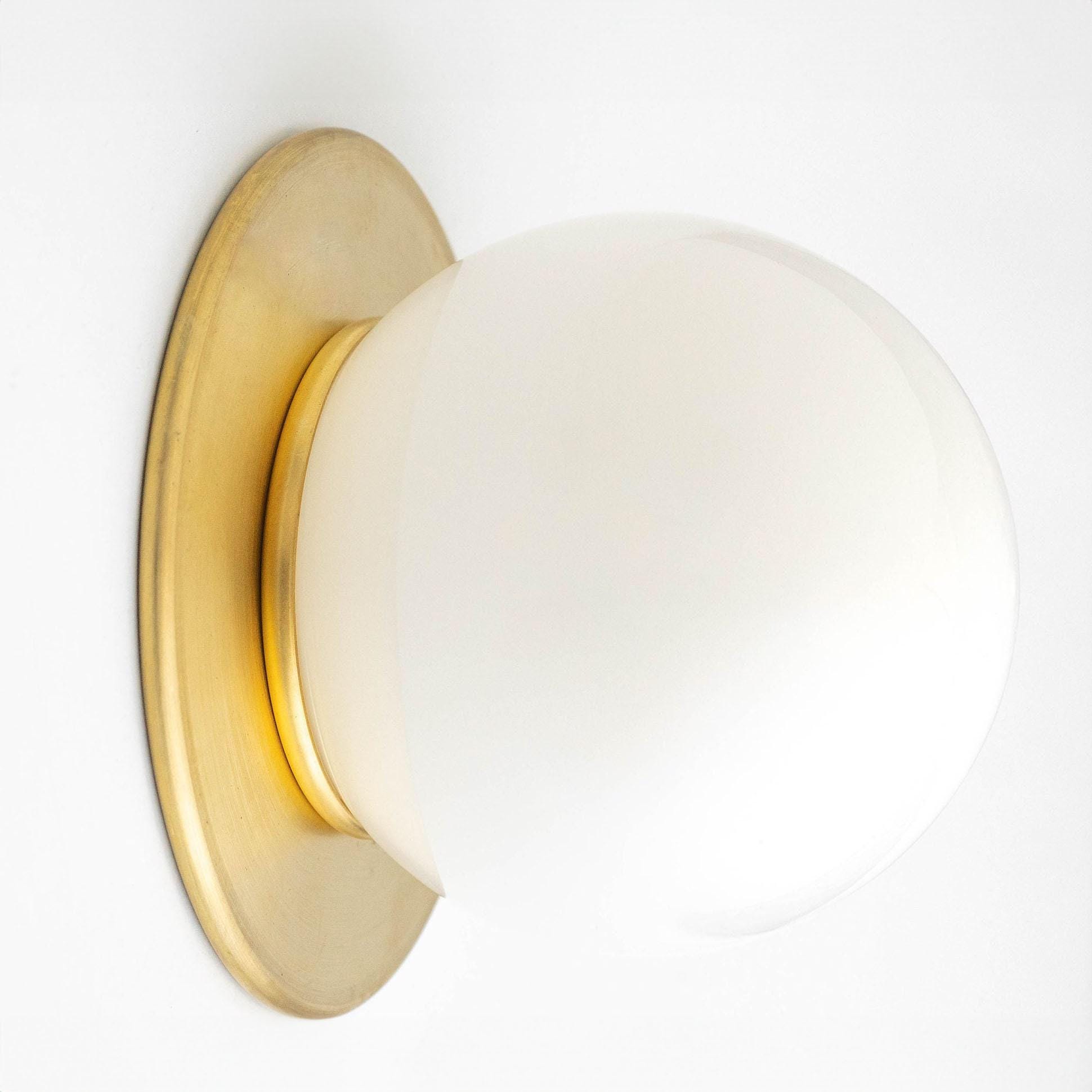 Mid-century modern wall sconce with raw brass base and white frosted glass globe. - SCONCE MODEL NO. 9364