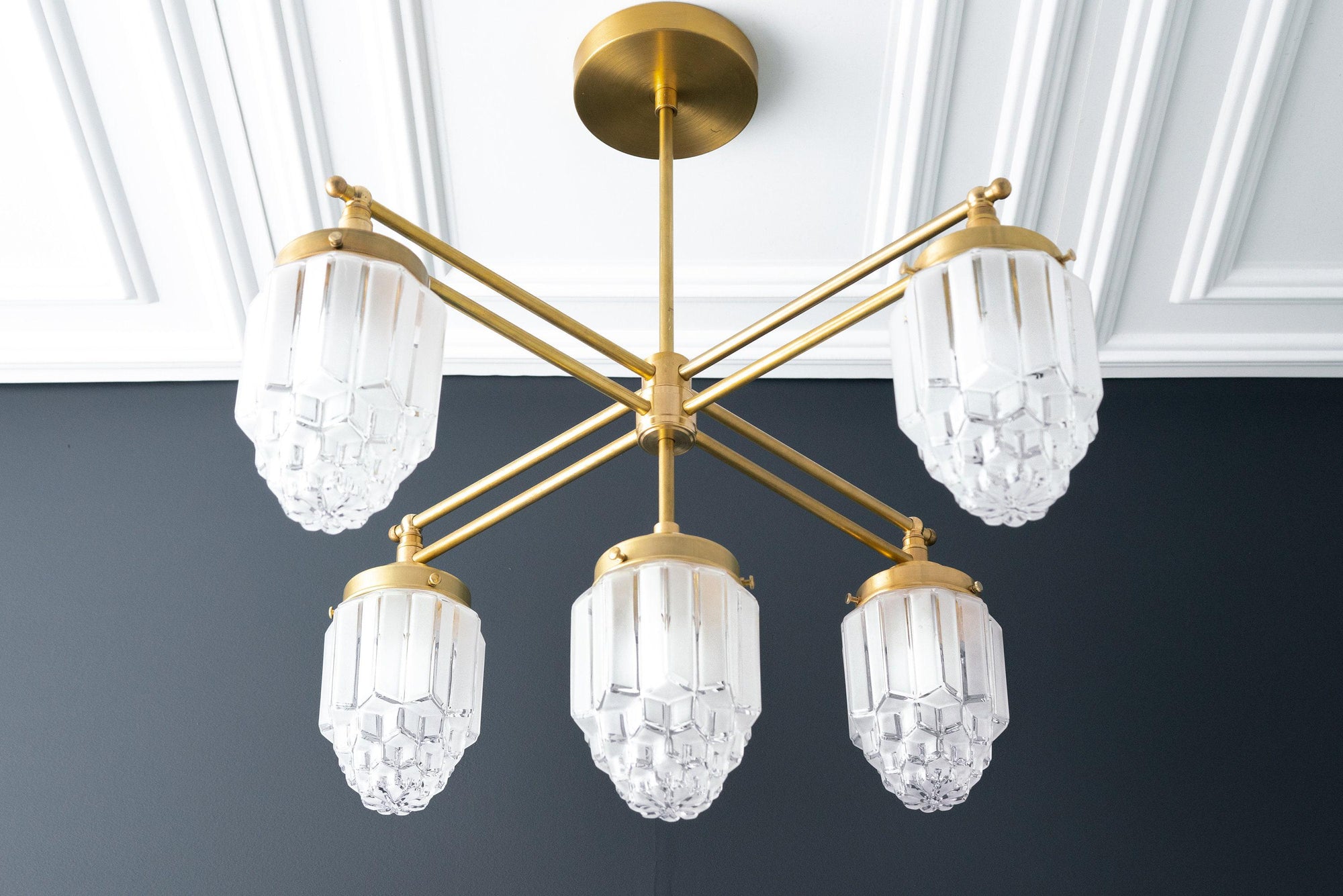 Raw brass Art Deco chandelier with five faceted globe glass shades and horizontal arms. - CHANDELIER MODEL NO. 5830
