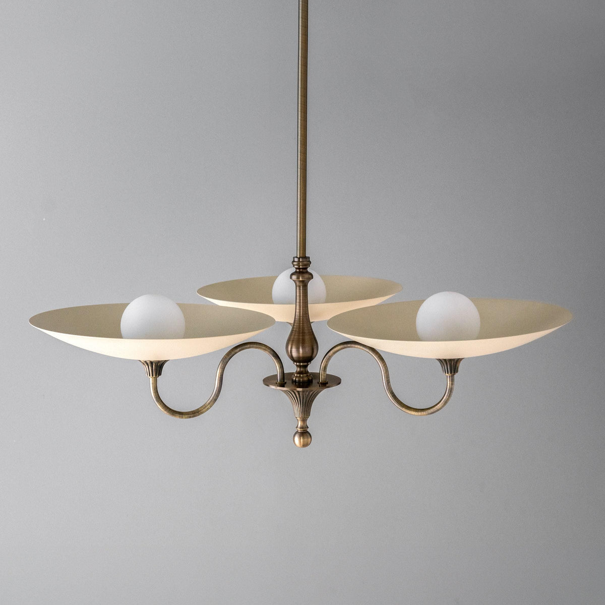 Antique brass chandelier with three cream globe lights and curved arms in modern Victorian style. - CHANDELIER MODEL NO. 1563