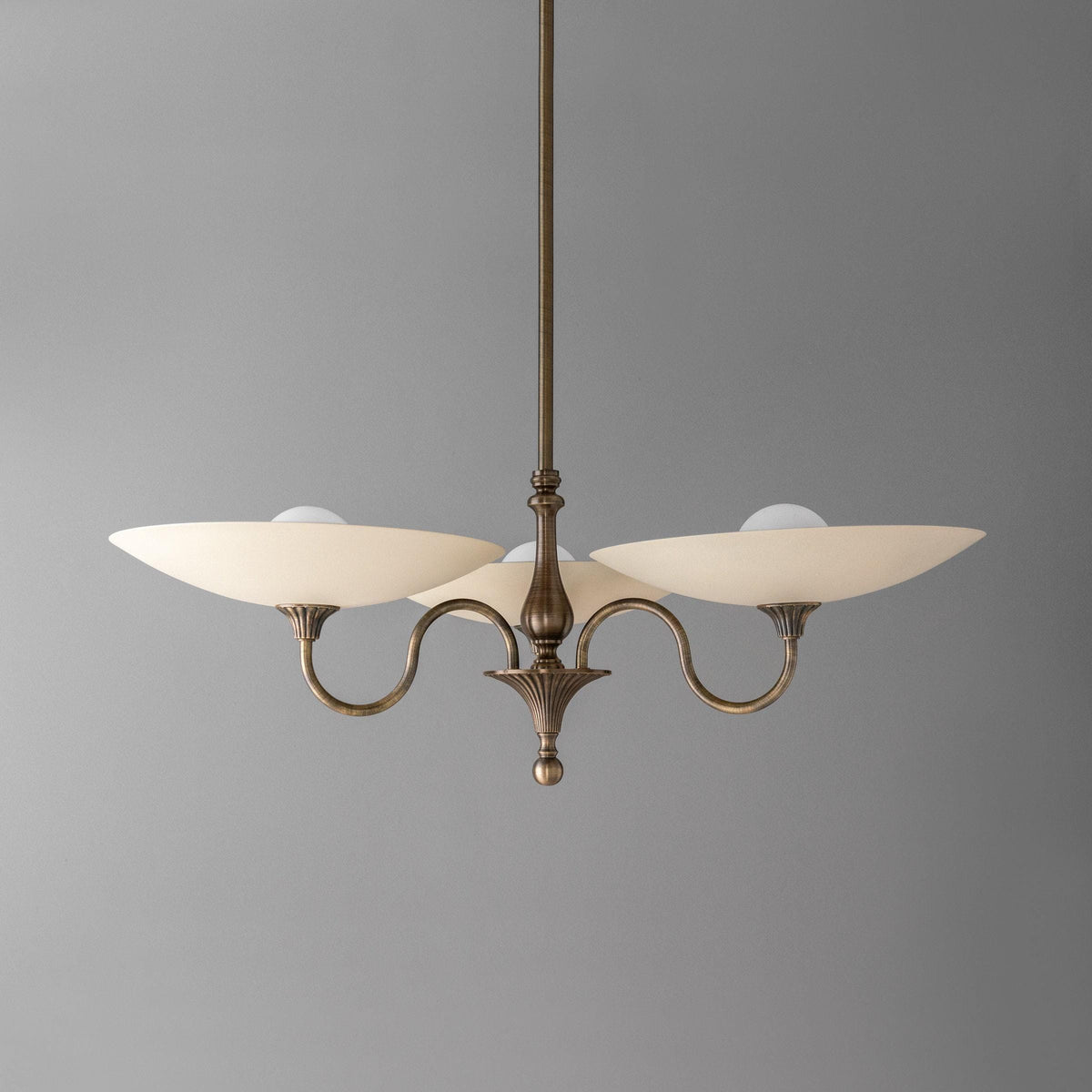 Antique brass chandelier with two curved arms and cream glass globes against gray background. - CHANDELIER MODEL NO. 1563
