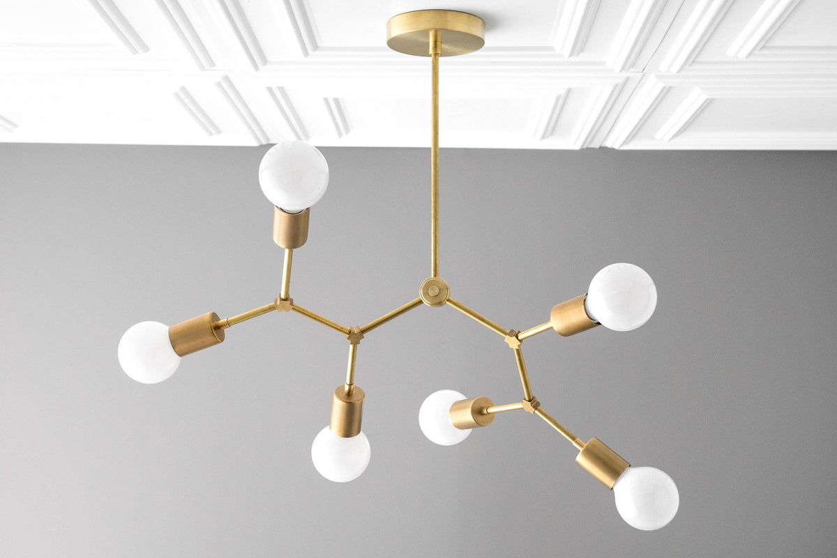 Raw brass Art Deco chandelier with six exposed white globe bulbs and angular arms. - CHANDELIER MODEL NO. 2523