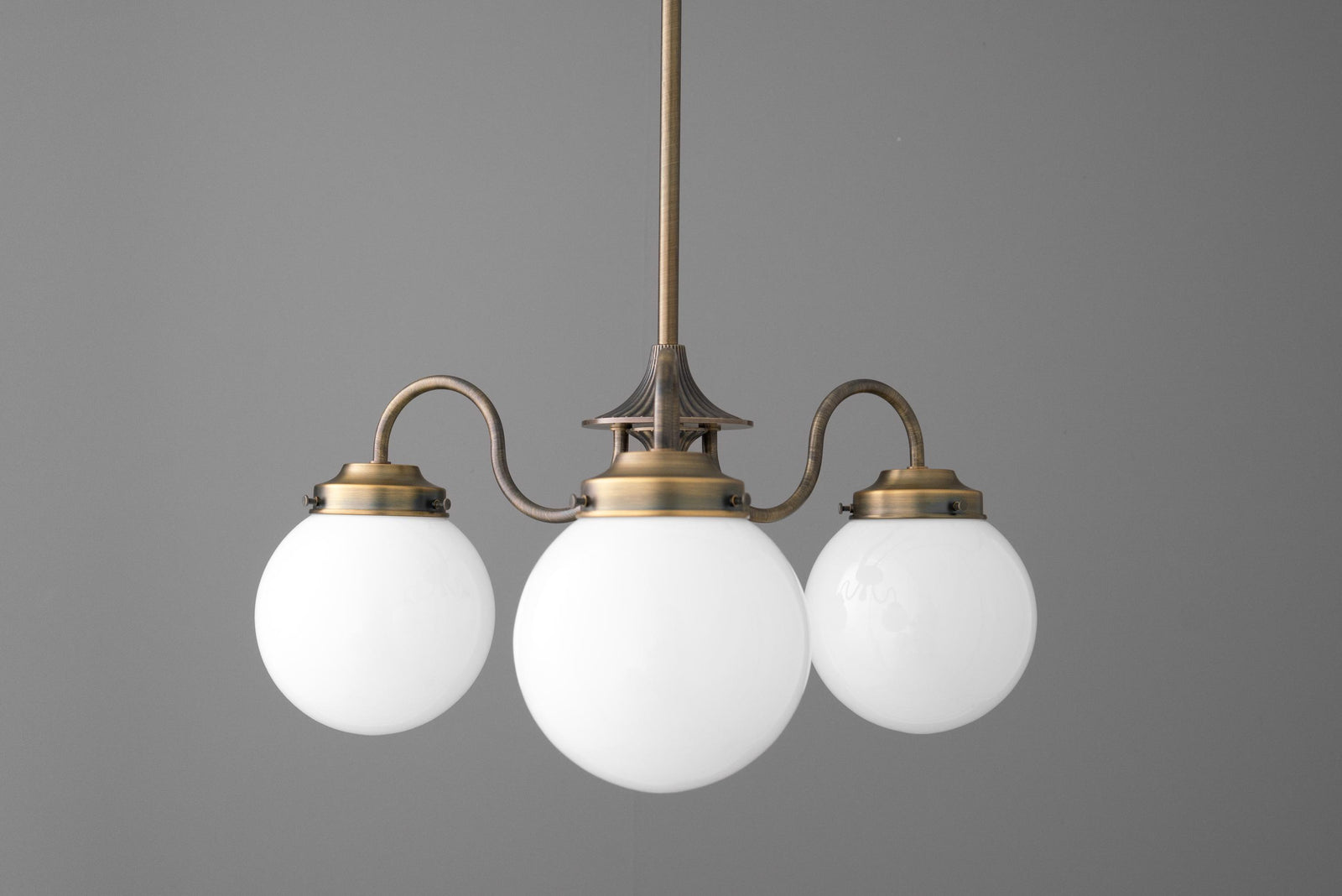 Three-globe chandelier with antique brass finish and white frosted glass spheres. - CHANDELIER MODEL NO. 5877